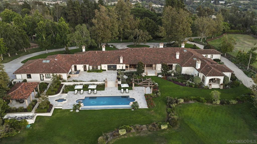 One-of-a-kind grand estate, set on nearly 12 pristine, usable acres in the Rancho Santa Fe Covenant, is the ultimate in luxury & seclusion. This exceptional legacy property evokes the romance of a private oasis & a dream escape filled with endless adventure. It lives the way you want it to live, as the ultimate family compound, dream equestrian property, or private sanctuary. Draped in mature trees & adorned with lush gardens & rolling lawns with a stocked pond. The entire estate was designed, rebuilt & completed in 2021.