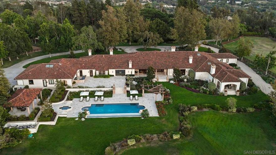 One-of-a-kind grand estate, set on nearly 12 pristine, usable acres in the Rancho Santa Fe Covenant, is the ultimate in luxury & seclusion. This exceptional legacy property evokes the romance of a private oasis & a dream escape filled with endless adventure. It lives the way you want it to live, as the ultimate family compound, dream equestrian property, or private sanctuary. Draped in mature trees & adorned with lush gardens & rolling lawns with a stocked pond. The entire estate was designed, rebuilt & completed in 2021.