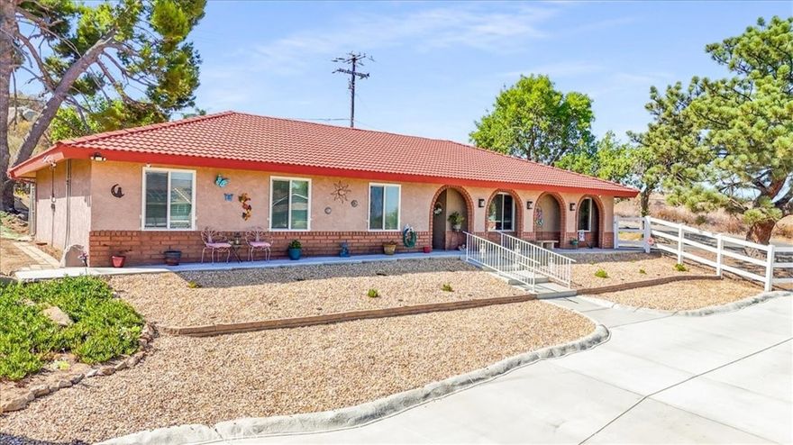 Welcome Home! Enjoy incredible views from this turnkey custom property featuring 4 bedrooms and 2 bathrooms on nearly one acre of land. Includes an additional parcel across the street, a 3-car garage plus an 800 sq. ft. shop/4-car garage with electricity, RV access, and water hose connectors throughout, making it ideal for horse lovers and outdoor enthusiasts. Interior upgrades include granite countertops, dual-pane windows, ceiling fans, air conditioning, a master suite with sliding door access, French doors in the living room, water purification system, garage sink, and new front and garage doors. Landscaped yards with sprinklers in front and back, farm-style white fencing, swing gate at the bottom, and powered front gate with remotes add charm and convenience. Enjoy Hemet city lights and sweeping views of the Big Bear and Idyllwild mountain ranges. Move-in ready with extensive upgrades, this home truly has it all. Come and see it for yourself!
