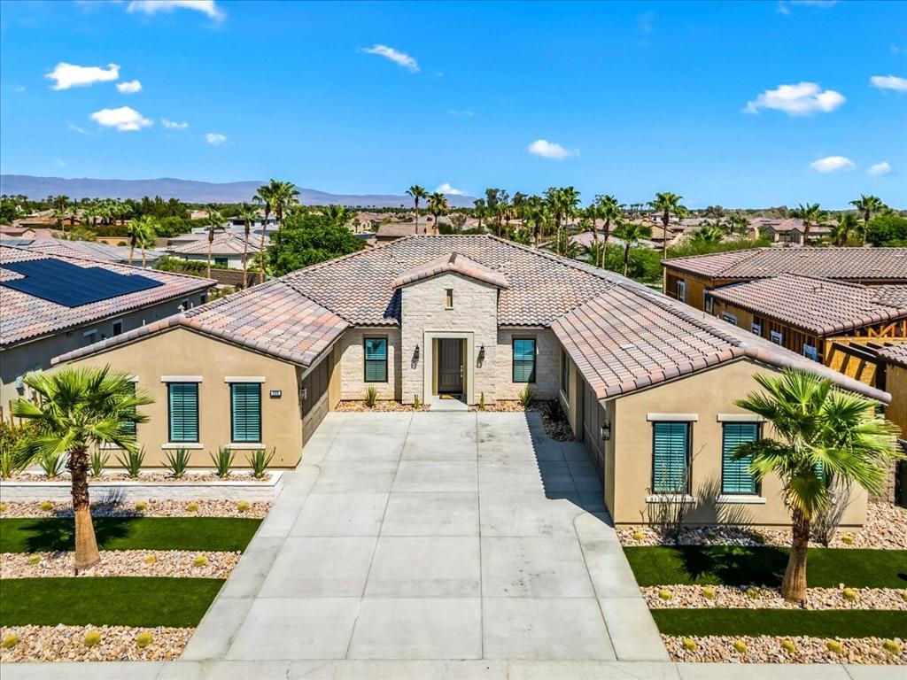 Welcome to unparalleled luxury behind the gates of Stone Creek in La Quinta - an exclusive estate that defines refined desert living. Step through the grand entrance into an expansive 4-bedroom suite residence, each with its own luxe bath plus an additional bath to complement this extraordinary home. Every detail has been thoughtfully curated: from the versatile flex room to the sophisticated office or library, adorned with custom glass walls. Experience breathtaking volume with soaring 12 foot-plus ceilings and a dramatic great room showcasing a floor to ceiling marble fireplace-perfect for elegant entertaining oe intimate gatherings. The outdoor living spaces rival world-class resorts. Enjoy seamless indoor-outdoor flow to a private entertainer's yard with a built-in-BBQ, fireplace, refreshing pool, relaxing spa, tranquil creeks and water features winding through below. CAR collectors and enthusiasts will appreciate the rare 4-car garage with epoxy finish - a true gem in La Quinta luxury real estate. Located minutes from world-renowned golf courses, premier tennis, scenic hiking trails, polo fields and iconic music venues such as Coachella and Stagecoach. This elegant estate offers a lifestyle beyond compare - more than a home - it's an invitation to live luxuriously, entertain stylishly and retreat privately at Stone Creek. Call Kelli today for your personal tour.