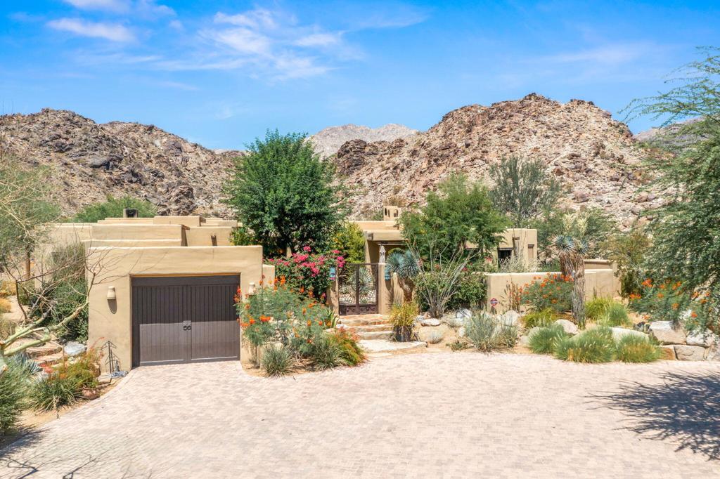 Tucked into the Cahuilla Hills of Palm Desert, this Exceptional and Enchanting Santa Fe-style estate offers unmatched privacy, panoramic views, and authentic architectural charm--just minutes from the upscale shops and fine dining of El Paseo. Situated on two expansive parcels totaling 7.63 acres, this 6-bedroom, 5.5 bath retreat is designed for luxurious desert living.The home features a separate master wing with dual suites and each has its own bathroom and private dressing room. There's an additional ensuite bedroom in the main house, and two private guest casitas--perfect for hosting family or friends. A richly appointed library with a dual-sided fireplace doubles as a bedroom, adding versatility to the layout.Showcasing exquisite craftsmanship and designer finishes throughout, this estate includes a spacious eat-in kitchen with a central island, a grand dining room, and a dramatic living room with soaring beamed ceilings, walls of glass, and a commanding fireplace.Step outside to discover the beauty of nature with multiple serene outdoor patios, a sparkling salt water pool and separate raised spa, with breathtaking mountain and valley views across nearly 8 acres. Located near the exclusive Stone Eagle Golf Club--with memberships available--this property is a true desert sanctuary for those seeking elegance, space, and tranquility.Offered Furnished per inventory list. Property conveys with Two parcels. APN# 628-130-010 (approx. 5.0 acres) and APN# 628-130-012 (approx. 2.55 acres) included.