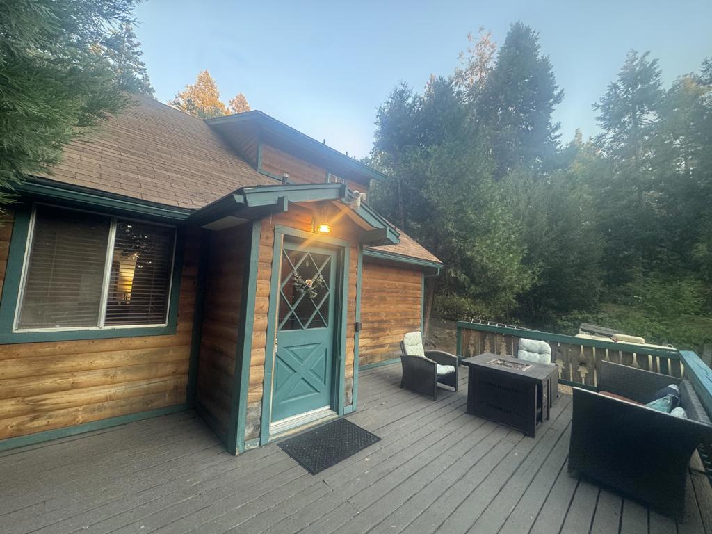 Charming Idyllwild home just 1 mile from town with a spacious driveway and sun-filled front deck-perfect for morning coffee or evening unwinding. Inside, cathedral and beamed ceilings, pine wainscoting, cedar paneling, and a brick fireplace create a warm mountain-lodge vibe. The updated kitchen boasts newer cabinetry, quartz counters, and stainless steel appliances, flowing into the dining area with doors to a cozy brick-accented patio and seating nook. A second patio with outdoor brick fireplace/grill invites alfresco dining under the stars. First floor offers laundry and half bath; upstairs features two bedrooms, including a primary suite with double-sink vanity, quartz counters, and full bath. Just minutes to hiking, shops, galleries, and dining. With Palm Springs/Palm Desert/Temecula wine county about an hour away. Ideal full-time home, weekend escape, or lucrative long-term rental in a sought-after mountain community. Great Opportunity in Idyllwild California.