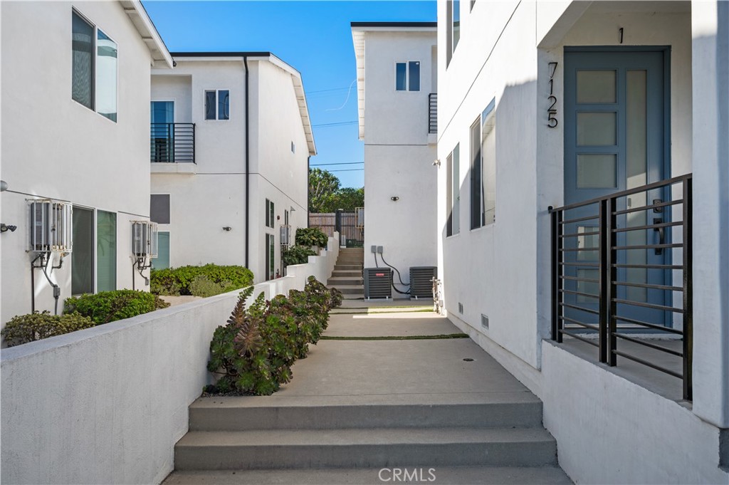Experience modern living at 7125 South La Cienega Boulevard, a gated 2020-built building offering 1,300 sq ft of thoughtfully designed space. This stylish 3-bedroom, 2 bathroom apartment features an open-concept main level with recessed lighting, laminate floors, and a modern kitchen boasting stainless steel appliances, quartz countertops, and a center island with bar seating—perfect for everyday living or entertaining. The spacious primary suite includes a deep closet with built-in organizers and a sleek en-suite bathroom. Additional amenities include central air conditioning, in-unit washer dryer, a private 1-car garage, plus one exterior parking space, and secure gated access. Ideally located near Fox Hills, Culver City, West Adams, and Westchester—with SoFi Stadium, LAX, and Playa Vista just minutes away.