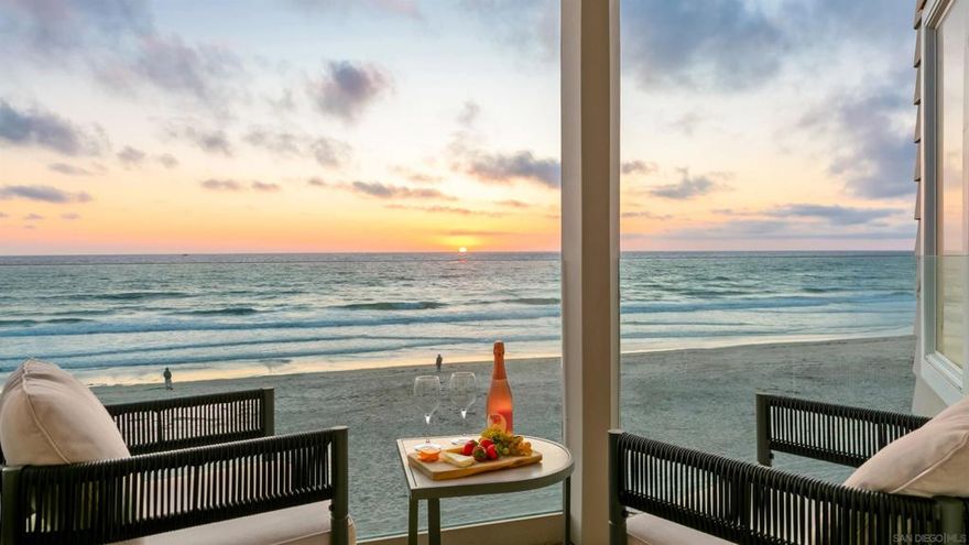 Welcome to your dream beach escape, a 2-bedroom, 2-bathroom oceanfront condo located directly on the Mission Beach boardwalk. This two-story residence offers unmatched views of the Pacific Ocean from nearly every room and provides direct access to the sand and surf just outside your door. Upstairs, the primary suite features a California king bed, wall-to-wall windows, and sliding glass doors that open to a private oceanfront balcony. The ensuite bathroom includes dual vanities, a walk-in glass shower with river rock flooring, and soothing coastal finishes. The second bedroom is equally comfortable, with a California king bed, smart TV, desk space, and an adjacent full bathroom with a combination tub/shower and dual sinks. The living area features a cozy fireplace and expansive windows that bring in natural light and fresh ocean air throughout the day. A TV is located in each room for added comfort and convenience. Please note, pets are not permitted in this home. The kitchen is complete with modern appliances, granite countertops, and a center island ideal for prepping meals. There is kitchen bar seating for four and a separate dining table. Additional amenities include in-unit washer and dryer, air conditioning, and a small designated parking space in front of the garage. Whether you’re here for work, rest, or play, every detail is designed to make your stay feel exceptional. Sleeping Accommodations (Maximum Occupancy 4): Bedroom 1 - 1 King bed Bedroom 2 - 1 King bed - There are a total of 2 bathrooms