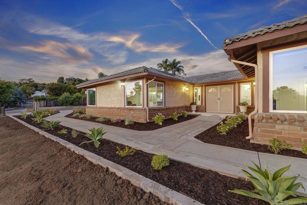 Outstanding Vista propertunity---this one has it ALL! Spacious 1.54 -acre lot, huge & updated single story main home, attached casita with its own kitchenette, tiny home on wheels, 3 oversized RV spots with water & power, plus SPACE to add a pool, animals like horses, goats, & chickens, a resort-style backyard, potential ADUs...the list goes on! Do not miss out on this one that is priced to sell quick in one of Vista's most desirable neighborhoods. Short drive to freeways, revitalized Downtown area, Cal-a-Vie, & the beach in Oceanside! The main home is huge with 5 bedrooms & an office area, large living spaces, tons of light, & a gorgeous updated kitchen with white cabinetry, stainless steel appliances, an oversized eat-at kitchen island with additional storage & walk-in pantry. A W/D was installed in the primary walk-in closet, including hot/cold water lines, drainage, a dryer vent, & a 220V outlet. In addition to the original primary suite with spacious ensuite bath, a second primary suite was created to allow increased flexibility & functionality of the floor plan. Part of the garage was converted into a dedicated office with half bath — ideal for remote or hybrid work. The attached casita with its own kitchenette is perfect for a nanny or property manager. It features its own private entrance, full kitchen (no washer), living room, large bedroom, & full bathroom. The entire house is wired with Cat6 cable, ready for mesh network & camera security system. The driveway & backyard was upgraded with Italian pavers. The spacious outdoor area is hardscaped & incredibly low maintenance. It features a hot tub & an external storage shed. A gate provides privacy & safety for kids & pets. The sellers terraced the 1.5-acre lot using beautiful Italian retaining wall blocks to create an upper terrace for the main house with a flat 0.25-acre area below with a long gravel driveway leading down to the tiny house & RV sites. The tiny house on wheels features an elevated wrap-around deck, a separate electrical sub panel (shared with RV sites), an electric water heater, connected water line, & a 2,000-gallon septic holding tank with 4” overflow pipe (perforated and spread across property) with easy access for future pumping. Each RV site (total of 3 on property) includes two water hookups, a 32-amp electrical hookup, connected water lines. The RV area also shares an electrical sub panel with the tiny house. The exterior laundry close can accommodate up to 2 washers and 2 dryers (gas or electric) & includes a dedicated electrical sub panel. Property includes a 60-panel solar system, a comprehensive French drain system, & a mesh network that covers the entire 1.5-acre property. All water lines on the property were converted to 1-inch lines. The sellers also planted 35 fruit trees just last month! This North County San Diego Dream Propertunity offers massive amounts of value, flexibility for multi-generational living & income potential, not to mention a sizeable lot to create your personalized resort-style oasis in the back hills of Vista. Do not miss this one!