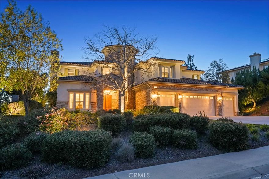 This extraordinary property nestled in the Foothills of Moorpark Country Club Estates combines appeal and luxury, making it the perfect place to call home. This stunning residence offers an unparalleled blend of timeless elegance, set against the backdrop of breathtaking mountains and the enjoyment of a scenic 27-hole golf course, at the nearby prestigious well-known Moorpark Country Club. Challenge yourself to tennis, pickleball or basketball. Designed for both relaxation and grand entertainment, this residence boasts exquisite architectural details, spacious living areas and resort-like out-door amenities, making it the ideal sanctuary for those seeking sophistication in a premier community. As you enter the impressive foyer you will be greeted with towering ceilings and a sweeping staircase. The formal living & dining room are perfectly sized and are enhanced by gorgeous yard views offering the ideal setting for your intimate dinners. Adjacent to the quaint breakfast nook and spacious breakfast bar you will enjoy creating meals in this fabulous, well-appointed kitchen featuring high-end appliances, ample counter space and custom cabinetry. Designed for both functionality & style. The family room open concept floorplan allows for a seamless flow, with beautifully crafted built-in entertainment & bar cabinetry. Conveniently located downstairs bedroom & bathroom are ideal for guest or multigenerational living. Secondary staircase leads upstairs to three secondary bedrooms, each with their own private en-suite, a luxurious junior suite and an impressive stunning primary suite with expansive windows that flood the space with natural lighting. The spacious layout provides room as a sitting area, fitness space or use your imagination. Sliding glass doors lead to a balcony, featuring views of the surrounding landscape and twilight sunsets. The primary bathroom is a true spa experience with a jetted soaking tub, walk-in shower, dual vanities and two expansive walk-in closets, let the relaxation time begin. Now, let's step outside to this true oasis, featuring a sparkling resort-like pool and spa, surrounded by lush landscaping & multiple lounging areas. Covered patio areas hosts an impressive bar-be-que station with bar seating, ready for your summer enjoyment. The outdoor pavilion offers out-door shaded seating with a grand fireplace with classic column accents. You will fall in love with this residence in the Country Club Estates.