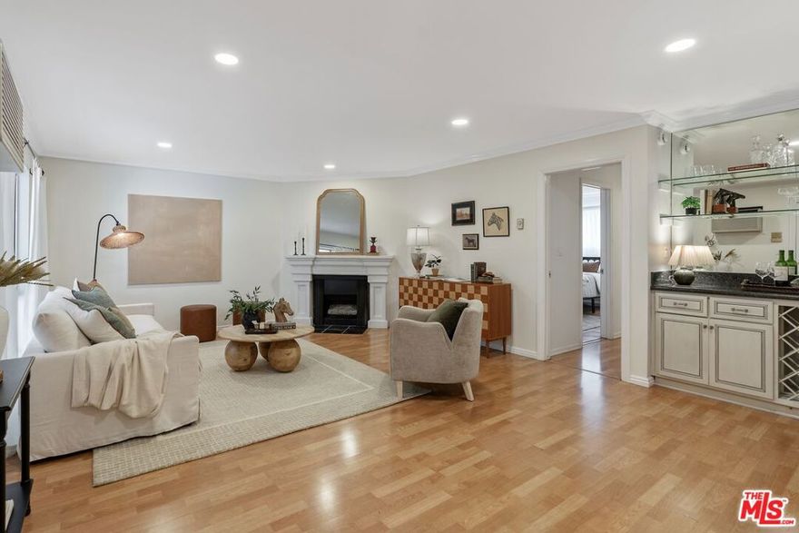 Discover the perfect blend of modern style and vibrant city living at this charming 2-bedroom, 2-bathroom condominium tucked in the heart of West Hollywood. This home combines thoughtful design and ease of living in one of the most sought-after locations in LA, offering comfort, convenience, and a dynamic lifestyle. Inside, you'll find a bright and open living space enhanced by a cozy gas fireplace, large windows, a built-in bar area with a wine rack, and brand-new recessed lighting that creates a fresh, inviting atmosphere. The modern kitchen is appointed with sleek granite countertops, contemporary cabinetry, and stainless steel appliances, while the open layout flows seamlessly into the designated dining area. Both bedrooms are generously sized, offering plenty of space for rest, work, or guests. The two full bathrooms feature updated finishes and add to the functionality and appeal of the home. For additional convenience, find newly-installed in-unit laundry and 2 side-by-side parking spaces in the gated garage. The lush landscaped community offers a sparkling community pool, BBQ area, additional laundry facilities and a communal hang-out space perfect for evening gatherings or entertaining. Location is where this home truly shines. Nestled between Melrose Avenue and Santa Monica Boulevard, residents are surrounded by some of the best dining, shopping, and entertainment in the city. Enjoy nearby icons such as The Pacific Design Center, West Hollywood Park, and the legendary nightlife along Sunset Strip. Renowned restaurants, trendy boutiques, and cozy cafes are just outside your door, while The Grove, Beverly Center, and Cedars-Sinai are only minutes away. With excellent access to nearby freeways and transit, the rest of LA is at your fingertips.