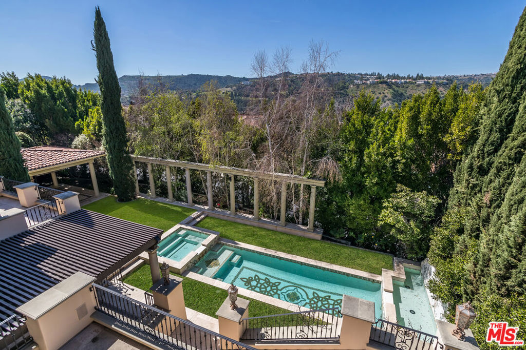 Amazing opportunity to acquire a move- in ready estate with tremendous upside in exclusive, guard gated Bel-Air Crest. This palatial villa, sited on a 24,000+ sf lot, features high end finishes, custom cabinetry and gorgeous views with 6 ensuite bedrooms plus a gym, study, and media room. The main level features a grand, 2 story, sky lit foyer with sweeping stairway. A stunning living room with coffered ceiling, and gracious formal dining room open to a large terrace for indoor /outdoor entertaining. There's an incredible, dine-in cook's kitchen which connects to the family room plus a spacious study, 2 powder rooms and a guest/maids bedroom with bath. Art collectors will love the high ceilings and gallery spaces, ideal for display. The upper level boasts a sumptuous primary suite with mountain views, an enormous walk- in closet, fireplace and sitting area with built ins plus three additional large bedroom suites each with custom closets and baths The. lower level opens to an entertainer's yard and includes a media room, gym (7th bedroom), wine cellar, laundry and another ensuite bedroom. An elevator and 2 staircases provide easy access to all floors. Private grounds feature exquisite mosaic pool, spa and heated outdoor living room with fireplace and custom outdoor kitchen. 3 Car garage parking plus additional in the gated drive. In addition to your personal amenities, Bel Air Crest offers a community gym, party room, pool, tennis and basketball court. Live like royalty in this impeccable residence. Photos are virtually staged and do not represent actual furnishings. Also Available for Lease