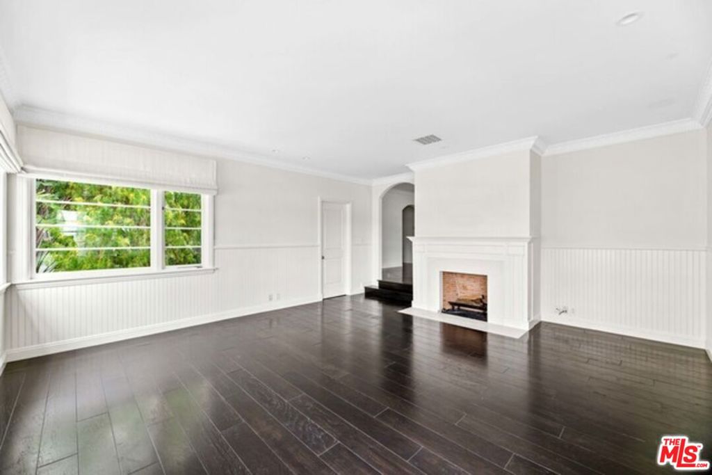 Space, design, and overall luxury create one of the best units in the building for someone looking to live moments away from SoHo House, the Sunset Strip, the Beverly Hills Hotel, and Rodeo Drive. 9233 1/2 Doheny Rd provides two (2) living areas: a formal living area housing a fireplace, a powder room, and corner windows allowing the space to shine naturally. A secondary living area includes a sliding glass door to a balcony and provides access to the main hall. Mahogany wood floors sprawl leading to the formal dining room, the kitchen, and three (3) naturally bright bedrooms with ensuite bathrooms. The kitchen houses stainless steel appliances, a farm sink, granite counters and backsplashes, along with the stacked Washer and Dryer. The bathrooms have been updated with quartz countertops, marble showers, mahogany cabinets, and satin nickel fixtures. The front and back entrances are equipped with an alarm system. Two (2) covered gated garage side-by-side parking spaces are included.