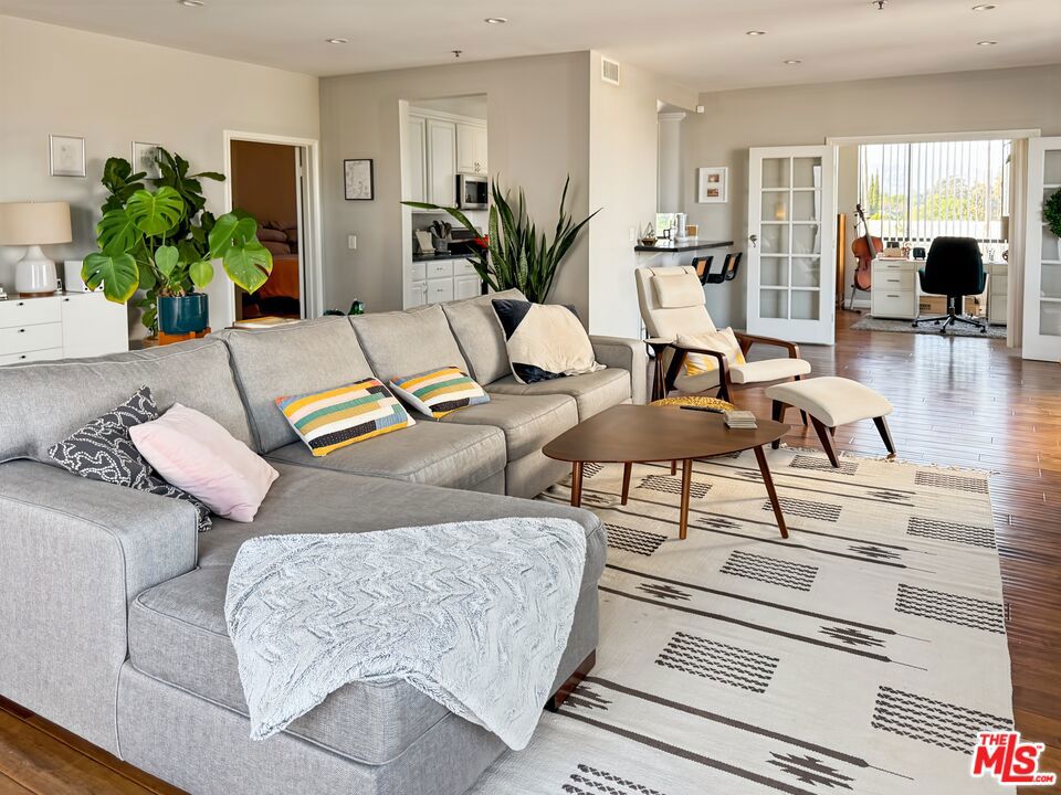 Welcome to this extra-large, beautifully designed condo in the heart of Windsor Square. This two-bedroom plus office, two-and-a-half-bath residence offers sweeping views, high ceilings, and an open, airy layout that fills the space with natural light.The home features gorgeous hardwood floors throughout, an immaculate kitchen perfect for entertaining, and a state-of-the-art spa-inspired primary suite complete with an oversized soaking tub and steam shower. A generous second bedroom and a bright office/den make this home ideal for modern living or working from home.Located near Larchmont Village, The Ebell Theater of Los Angeles, and the prestigious Marlborough School, this residence provides the best of city living. Stroll to neighborhood shops, restaurants, and grocery stores including California Mart, H Mart, Ralph's, and Zion Market. With easy access to public transit and major freeways, you'll enjoy convenience at every turn.This is an exceptional opportunity to live in one of Los Angeles' most sought-after neighborhoods.