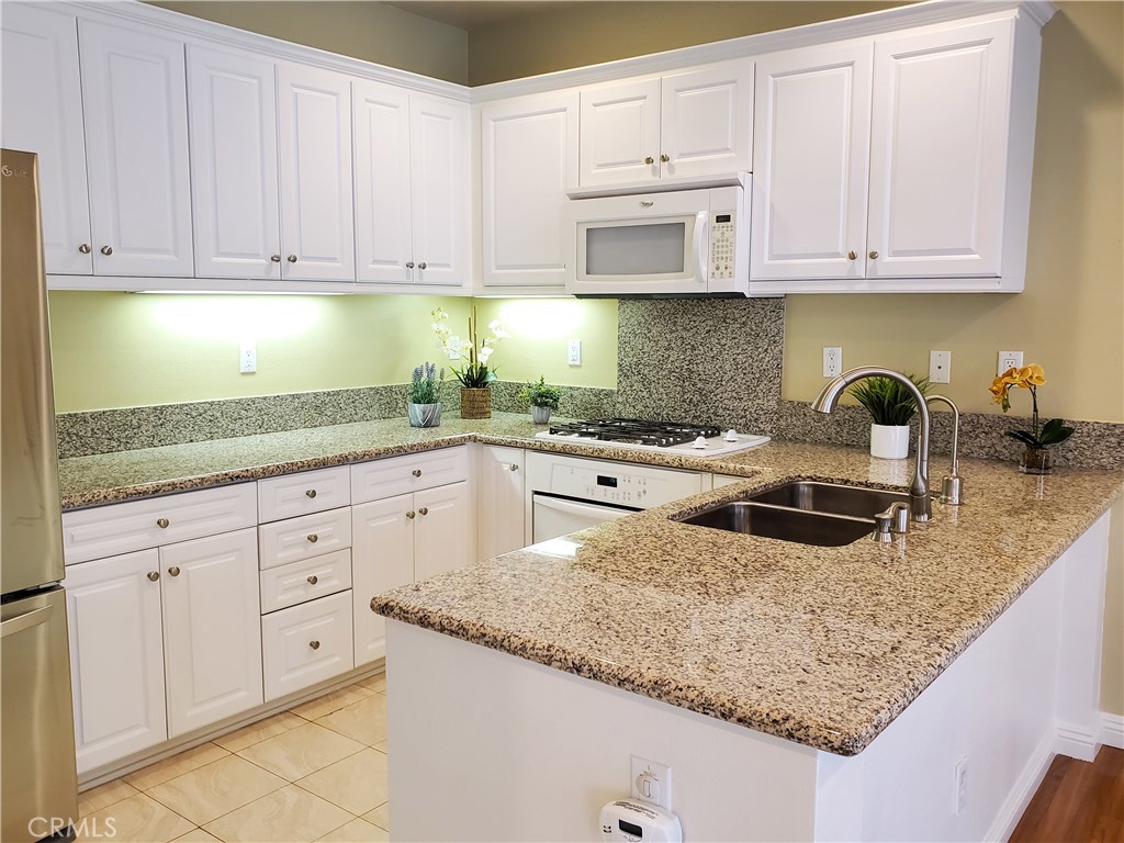 Wonderful opportunity to enjoy life in the beautiful, well-kept, gated community of "Village on Oak" in charming Old Torrance! Built in 2007, this spacious 2 bed 2.5 bath townhome has an impressive 1330 sq.ft. of living space! The main living area features an open layout with living room next to the dining area and dining adjacent to the kitchen. The sliding doors by the dining area lead to a good size balcony. The fabulous living room features an gas fireplace, recessed lighting and a half bath. The large kitchen boasts of granite counter top with breakfast bar, ample cabinet space, gas stove, dishwasher, and stainless steel refrigerator. Upstairs you will find a stackable washer/dryer tucked away in a closet, a master suite with walk in closet, master bath with dual vanities, soaking tub and a second bedroom, and second full bathroom. Additional features including: central A/C and heating, direct access to attached 2-car garage, dual pane windows and wood laminate flooring throughout! This resort like community offers a beautiful pool, spa, 2 built in BBQ’s, a sitting area with cozy fireplace and playground which is perfect for entertaining and relaxing. Convenient location! Short walk to Wilson Park and it’s Farmers' Market on Tuesdays and Saturdays mornings. Easy access to freeways, shopping, markets, restaurants and the beach. Very quiet and well maintained community. Don’t miss out on this great opportunity! No smoking. One small pet may be considered, please call to verify.