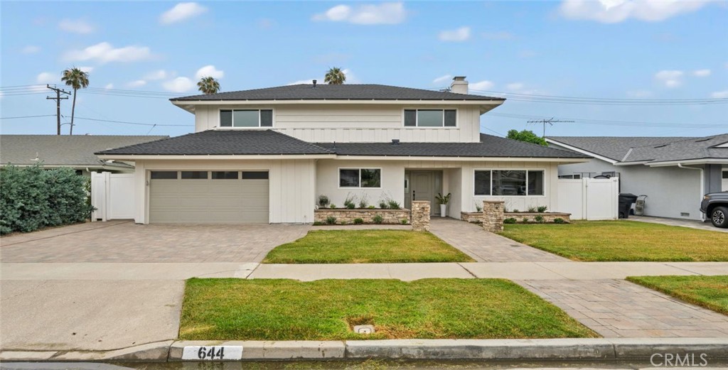 Welcome to 644 Kenoak Dr. A Turnkey Family Retreat in the Heart of Placentia. This beautifully remodeled home offers 2,501 sq ft of sophisticated comfort, blending modern upgrades with vibrant indoor and outdoor living. Nestled in one of Placentia’s most desirable neighborhoods, it provides an exceptional lifestyle with access to acclaimed schools and convenient amenities. Step inside to find luxury vinyl plank flooring, fresh paint, and a floor plan that ensures effortless flow between living, dining, and family spaces. The updated kitchen features quartz countertops, newer cabinetry, and stainless steel appliances, new sink faucet and kitchen disposal—perfect for both everyday living and entertaining. Upgraded with a brand new roof. The flexible layout includes a spacious primary suite, and two additional bedrooms ideal for family, guests, or a home office. The property is physically three bedrooms. Prior ownership converted the oversized primary bedroom from two bedrooms into one. The downstairs living room could be easily converted into the formal fourth bedroom. Complimented with a downstairs bathroom with walk in shower and 2 bathrooms upstairs that offer modern finishes and convenience for all. Designed for year-round enjoyment, the expansive backyard features a built-in outdoor grill, turf play area, and a private basketball half court—a unique highlight for active households. There’s ample space for outdoor dining, gardening, and relaxation.