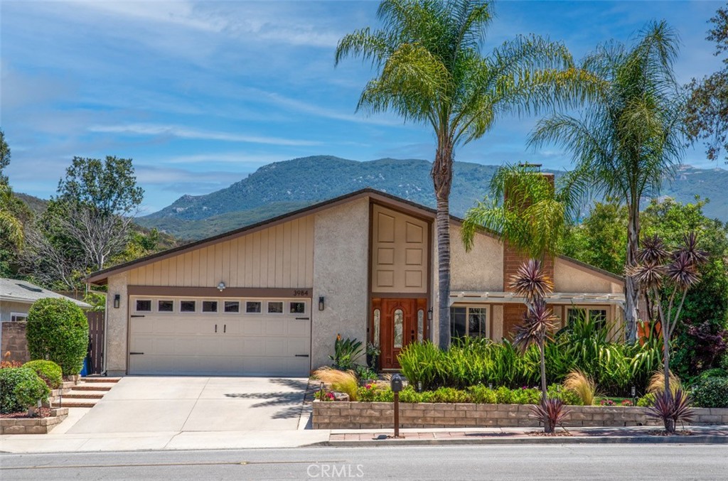Discover exceptional charm and comfort in the heart of Newbury Park, where timeless elegance meets modern living in one of the Conejo Valley’s most desirable neighborhoods! This warmly inviting one-story ranch home, nestled within the award-winning Conejo Unified School District, is steps from top-rated Cypress Elementary and Newbury Park High School. Featuring a NEW 2025 ROOF, NEW WATER HEATER, newer HVAC, and numerous upgrades, this well-built gem is a rare find. Enter a spacious open living room with vaulted ceilings and a cozy fireplace, perfect for gatherings. The family room flows seamlessly into a bright dining area with an oversized picture window, ideal for gathering and game nights. The gourmet eat-in kitchen dazzles with granite counters, stainless steel appliances, a substantial island, and abundant cabinetry. Additional dining room or flex space adjacent to kitchen opens to a serene backyard. Skylights brighten the hallway leading to a spacious primary suite with double doors, a walk-in closet, and a luxurious bath boasting dual vanities, a bathtub, and a private shower. 3 additional bedrooms offer ample closet space and bright south-facing windows. Outside, a unique front patio oasis with a pergola and tropical landscaping welcomes you, while the private backyard retreat features a large, covered patio, grassy yard, and lush gardens. With quick access to parks, trails, bike paths, and picturesque mountains, plus nearby stores and restaurants, this home blends convenience and the best of SoCal living, just minutes away from beautiful beaches. The 2-car attached garage features a countertop for workshop projects flanked by built-in cabinetry for storage. Other extras to note: Dual-paned Milgard windows. Automatic sprinklers front and back, 6 Ceiling fans, Recessed lighting, Wood and vinyl blinds throughout. EV charging in driveway. No HOA! Don’t miss this entertainer’s delight in a peaceful, family-friendly community.
