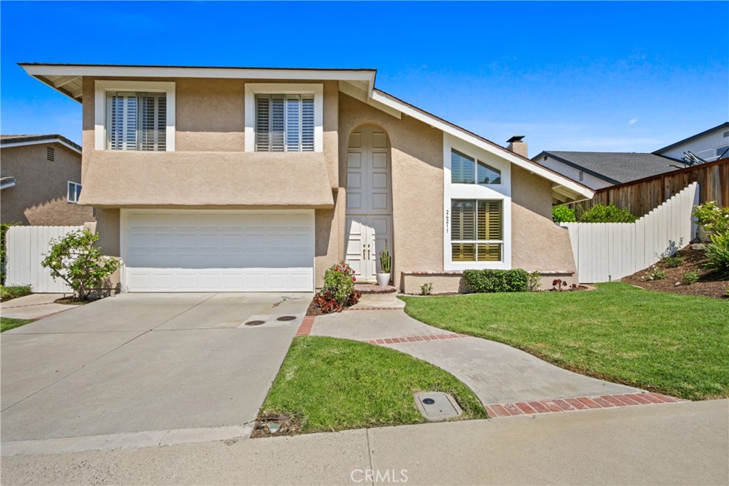 Welcome to 24211 Puerta De Luz, Mission Viejo. Located in one of Mission Viejo’s most desirable neighborhoods, this property offers an excellent opportunity for buyers looking to update and make it their own. This 4-bedroom, 2.5-bathroom home with over 2,200 sq. ft. of living space is ready for you to create your own vision of a family sanctuary. Step inside to discover bright, open main living areas that flow effortlessly, creating the perfect family-friendly environment. Upstairs, four spacious bedrooms provide privacy and comfort for everyone in the household. At the heart of the home, the kitchen welcomes you with warm, charming blue tile counters, crisp white appliances, and white cabinetry. It opens seamlessly to the family room and casual dining area, making everyday meals and gatherings comfortable and convenient. For special occasions, a formal dining room is available to host memorable celebrations. Throughout the home, durable luxury vinyl flooring combines style with practicality, while a vaulted living room fills the space with natural light. A cozy fireplace adds warmth and comfort, making it an inviting family gathering spot. Beyond aesthetics, essential systems have been thoughtfully updated for peace of mind. Newer heating and cooling systems—including ducts replaced in 2020 and 2023—along with relined sewer lines (2023), a whole-house water line re-pipe (2021), and a new water heater (2021) ensure reliable, worry-free living. Step outside to the expansive backyard, a private oasis featuring a sunshade-covered patio. This generous outdoor space offers plenty of room for entertaining or creating a personalized retreat. The wide side yard is ideal for garden plots, additional seating, or extra storage, while ample space awaits your vision for a custom swimming pool or ADU to complete this perfect family haven. Enjoy the benefits of Lake Mission Viejo, which provides exclusive access to a private clubhouse, yacht club, movies, beach concerts, swimming, and boat rentals. Perfectly situated just 5 minutes from major freeways and minutes from top-tier shopping, dining, and the Mission Viejo Public Library, this home is also part of the award-winning Saddleback Valley Unified School District, with Montevideo Elementary, La Paz Intermediate, and Mission Viejo High—all highly rated—just two minutes away. This warm, inviting home combines thoughtful design with a prime location—ready to welcome your family and create lasting memories together.