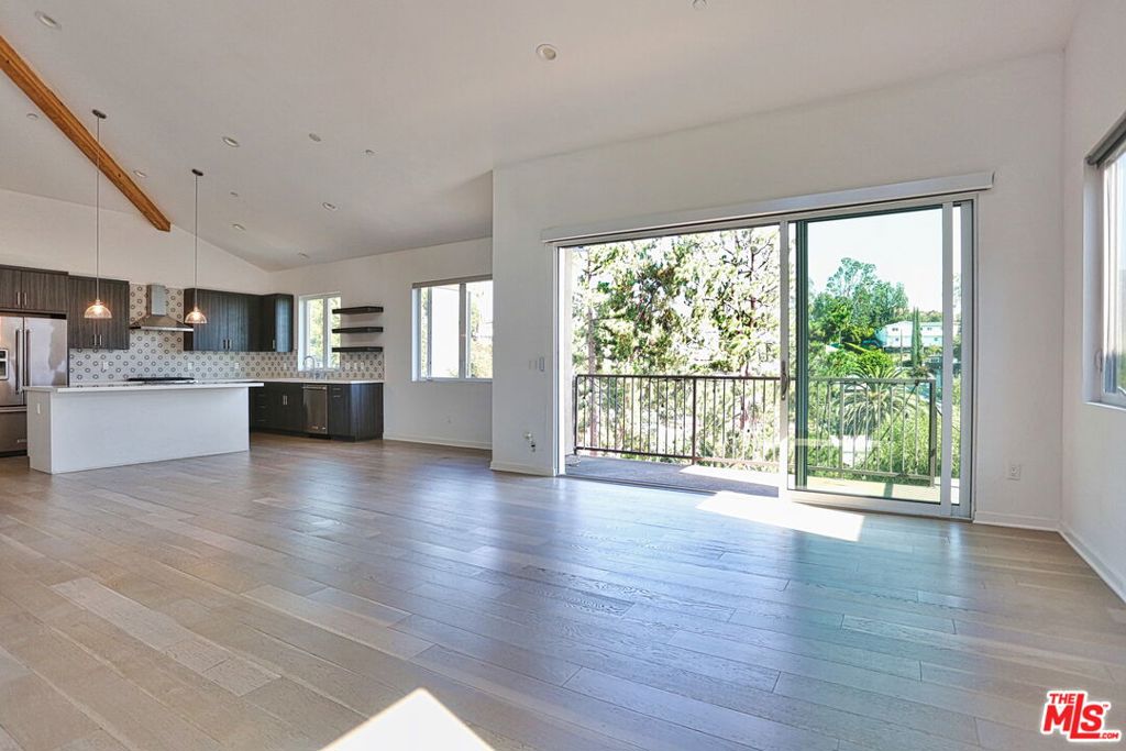 Perched on top of the hills of Elysian Heights is this light-drenched contemporary home with stunning city and hillside views. Built in 2016, this clever home offers all of the modern and convenient features you could need. Features begin with vaulted ceilings, a gas fireplace, and an entertainer's kitchen with a large center island in the generous open concept main living space. The living room, kitchen, full bathroom, bedroom/office/home gym are all on the street level while three bedrooms and two bathrooms are downstairs, offering a reverse-type floor-plan. The entryway opens into this beautiful space and through the living room, one can open the retractable glass wall system to a balcony featuring views of the Elysian Heights hills, Downtown Los Angeles, evening city lights and even the fireworks of Dodger Stadium. Downstairs, the primary suite features a walk-in closet, large glass surround shower, and French doors that open to an expansive deck. Beyond the back deck, you'll find a sparkling built-in spa, modern fire-pit, and patio space. Enjoy BBQs with the built-in outdoor kitchen and grow your own herbs, veggies and fruit in the additional garden space. This home is both comfortable and impressive, practical and fun. Work from home in one of the bedrooms that can double as a home office, or be able to have the perfect guest space on the main level for family and friends. Central HVAC system with an additional dual mini-split system for the living room and primary bedroom provides an energy-efficient climate control option. Attached two-car garage equipped with a 240v plug for EV car charging. Enjoy the convenience of nearby fine and casual dining, grocery stores, hiking trails, and local entertainment.