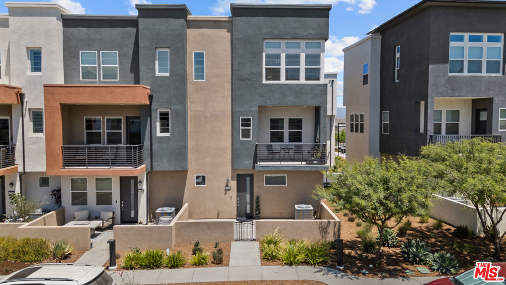 Sophisticated Turnkey Townhome in the Prestigious FivePoint Community. This beautifully appointed, model-like residence showcases impeccable taste and pride of ownership throughout. From the moment you enter, you'll be captivated by its sense of luxury, elegance, and thoughtful design. Featuring three spacious bedrooms and four bathrooms, this stunning end-unit home offers an ideal blend of comfort and sophistication. The gourmet chef's kitchen is a true showpiece, boasting upgraded cabinetry, striking countertops, designer backsplash, a large center island with seating, stainless steel appliances, and abundant storage. The elegant dining area flows seamlessly into the expansive living room with a private balconyperfect for entertaining or relaxing. The primary suite is a serene retreat with picturesque views, a luxurious spa-inspired bathroom with an oversized shower, and a generous walk-in closet. Additional features include designer flooring, recessed lighting, stylish chandeliers, and a convenient laundry room. Enjoy the private patio areas, ideal for outdoor dining and gatherings. The home also offers a two-car garage, tankless water heater, EV charger, and leased solar panels providing energy savings. Residents of FivePoint enjoy world-class resort-style amenities, including a state-of-the-art clubhouse, Olympic-sized pool, spa, athletic fields, walking trails, BBQ areas, and parks all within close proximity to award-winning schools, premier shopping, and easy freeway access.
