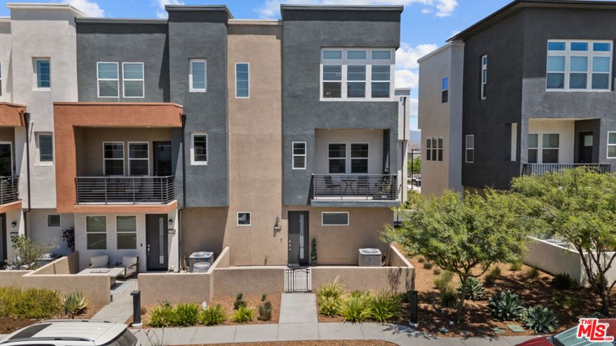 Sophisticated Turnkey Townhome in the Prestigious FivePoint Community. This beautifully appointed, model-like residence showcases impeccable taste and pride of ownership throughout. From the moment you enter, you'll be captivated by its sense of luxury, elegance, and thoughtful design. Featuring three spacious bedrooms and four bathrooms, this stunning end-unit home offers an ideal blend of comfort and sophistication. The gourmet chef's kitchen is a true showpiece, boasting upgraded cabinetry, striking countertops, designer backsplash, a large center island with seating, stainless steel appliances, and abundant storage. The elegant dining area flows seamlessly into the expansive living room with a private balconyperfect for entertaining or relaxing. The primary suite is a serene retreat with picturesque views, a luxurious spa-inspired bathroom with an oversized shower, and a generous walk-in closet. Additional features include designer flooring, recessed lighting, stylish chandeliers, and a convenient laundry room. Enjoy the private patio areas, ideal for outdoor dining and gatherings. The home also offers a two-car garage, tankless water heater, EV charger, and leased solar panels providing energy savings. Residents of FivePoint enjoy world-class resort-style amenities, including a state-of-the-art clubhouse, Olympic-sized pool, spa, athletic fields, walking trails, BBQ areas, and parks all within close proximity to award-winning schools, premier shopping, and easy freeway access.