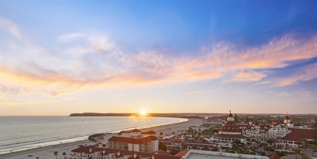Experience resort-style coastal living at its finest in this corner residence at The Coronado Shores. Sweeping, unobstructed views stretch from the Pacific Ocean and Point Loma sunsets to the Hotel del Coronado, Glorietta Bay, the San Diego skyline, and the Coronado Bridge—an ever-changing backdrop of coastal beauty. Ideally located across from the Hotel del Coronado, this home has dining, shopping, and beachside strolls just steps away. Recently remodeled, it features quartz countertops, ceramic tile flooring, and floor-to-ceiling sliding doors that frame the views. Custom cabinetry includes a walk-in pantry, built-in storage, and a walk-in master closet with drawers, while a mirrored living room wall amplifies natural light and views. Smart home technology enhances everyday living with programmable sheer and blackout shades, a keyless entry system, Sonos surround sound, and Sub-Zero, Wolf, and Miele appliances. Designer-selected furnishings are available separately for a true turnkey experience. More than a home, this is a rare opportunity to live the Coronado lifestyle in an unparalleled oceanfront setting.
