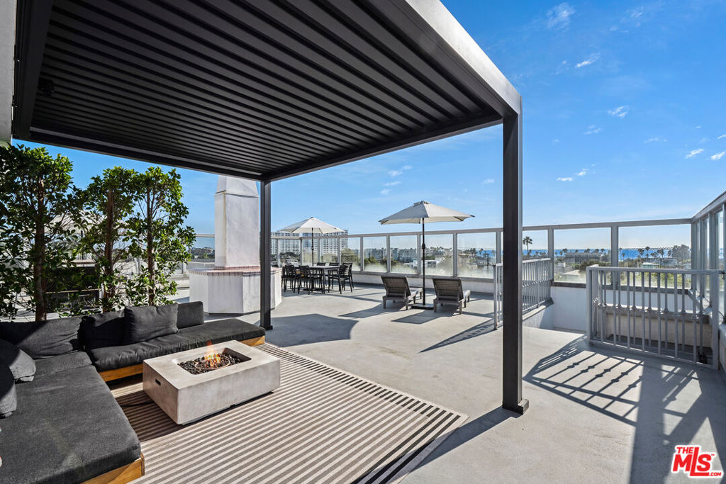 Experience the best of Santa Monica living in this beautifully updated 1-bedroom, 1-bath corner condo. Ideally situated 3 sunny blocks from the iconic Santa Monica State beach in the coveted, and supremely walkable neighborhood of Ocean Park. Filled with natural light, this inviting space features a spacious open-concept living and dining area, modern kitchen with stainless steel appliances, and quartz countertops. The private balcony offers a partial ocean view, ideal for soaking in ocean breezes and evening sunsets. The well appointed bedroom offers ample storage space with a walk-in closet and custom made mirrored wardrobe system. The stylishly renovated bathroom provides a spa-like retreat perfect for relaxation. With abundant windows positioned at the tree line of mature Jacarandas, this corner unit is one of the brightest and most private in the building. Located at the back of the building, it is also one of the most peaceful.Take entertaining to the next level on the rooftop deck. Located on the same floor as the unit, this unique amenity offers jaw-dropping 180 degree views of Santa Monica, the mountains and ocean. The space is perfect for morning yoga and coffee, or for magical al fresco dinners with friends and family. The building is secured with gated entry on all sides of the property, and features a mail room, washer and dryer with Pay Range, elevator and 2 tandem parking spots with bonus private storage.Experience the joy of living steps away from the beach as part of the beautiful Hillside Park community. Trendy cafes, beautiful boutiques, Abbott Kinney, the iconic Santa Monica Pier, and the best of the city's vibrant activities are available to you at a moment's notice. Whether you're seeking a serene beachside escape or a stylish space to explore the energy of the city, this home provides the ultimate in comfort, convenience and coastal charm.