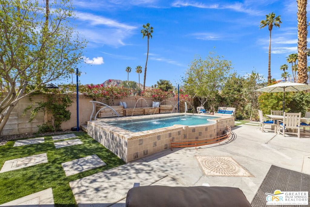 WOW! Check out this FANTASTIC opportunity in Tamarisk Heights that is an ideal match for those seeking CONTEMPORARY LIVING in South Rancho Mirage! Located within minutes to restaurants, retailers, and multiple country clubs, this home has been FRESHLY STYLED UP! Key highlights include tall ceilings, clerestory windows, open floor plan, contemporary finishes and tile flooring throughout, great separation of bedrooms, and an ultra-private south-facing backyard that includes a private saline pool, mature landscaping, and views of the surrounding mountains! Fresh interior paint plus recent system upgrades including a HVAC unit and tankless water heater. No land lease and no HOA fee, either! Custom-designed front door and formal entry with clerestory windows work to create a scene of magic that continues into the grand Great Room that features tall ceilings, eight clerestory windows, mountain views, and three sets of doors that open to the south-facing backyard that is anchored by a refreshing pool with custom water features. Adjacent kitchen, which looks into the Great Room, includes contemporary cabinets, stainless appliance suite including gas range with pot filler, and an oversized detached island with stainless steel farm sink and built-in counter bar ideal for both casual living as well as entertaining! This IS the floor plan for people who love to entertain! Primary Ensuite has been styled up with a fireplace, large walk-in closet, and private contemporary bath with dual sinks, quartz counters, large walk-in shower with four showerheads, and a separate jetted tub. A true SPA experience! On the other side of the house is Junior Ensuite Two with clerestory window, access to the outside, and a private bath that includes a walk-in shower. Separate powder/guest bath, too! Don't miss out on this incredible opportunity in Tamarisk Heights!