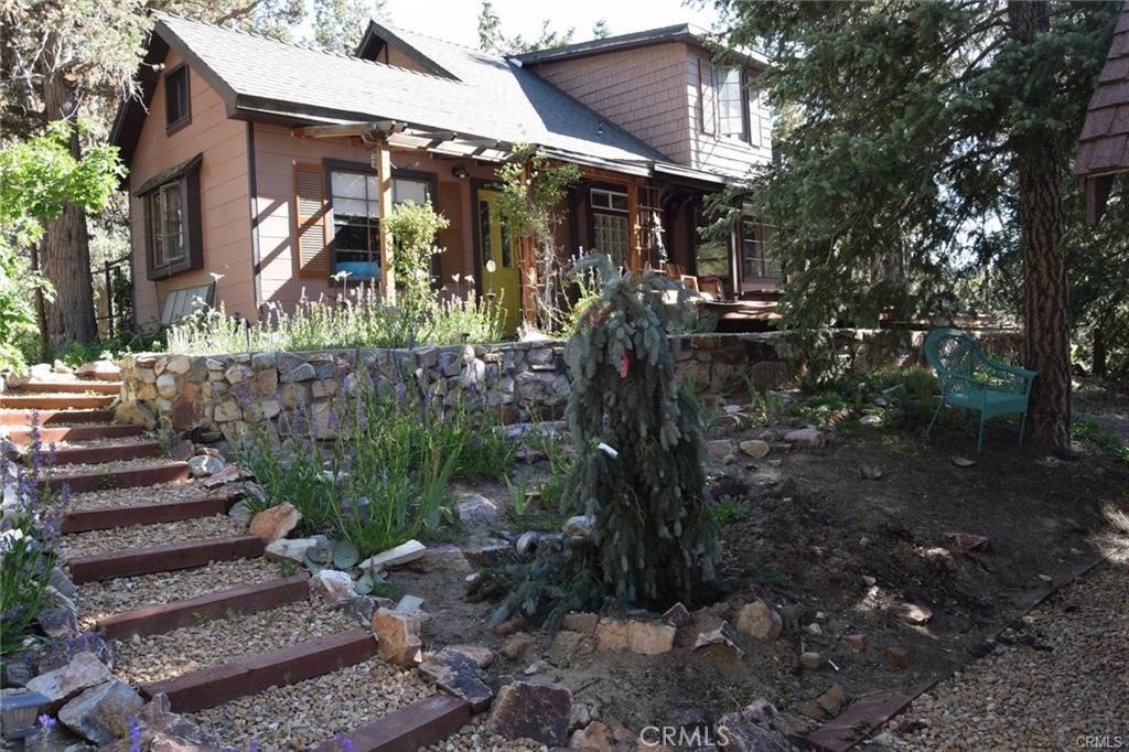 This 5 bedroom, 2 1/2 bath Victorian Craftsman home has 1508 square feet on a double lot overlooking both Snow Summit and Bear Mountain. The tram to the slopes is within walking distance, and the resort is a quarter mile away. The golf course, bike trails, walking path by a stream and the zoo are all part of the immediate neighborhood. Grocery stores are nearby. There is room to build an apartment with a 2-car garage with a sweeping view of the slopes. The house is known as The Magic Castle in Enchanted Evergreen Forest with Airbnb. This house was hand built with redwood and was the original property in lower Moonridge known as the Moonridge Mountain Estates, and it owned many more lots at that time. The house is completely private surrounded with trees, and each bedroom does not share a wall or floor with another bedroom. An attached apartment with its own entrance has an 11 x 16 loft space above for more storage. The home needs some upgrading and improvements but they are cosmetic only. With a little TLC this could be your resort dream home or as a short or long term rental and investment. Enjoy views of Snow Summit from the large Trex deck, fireworks from the front porch, and the Torchlight Parade on New Year’s Eve from upstairs. With its prime location, historical charm, and expansion potential, this is one of the most versatile fixer opportunities in Big Bear.