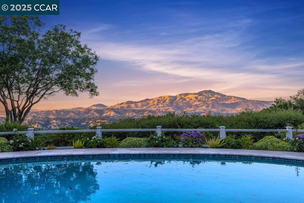 Welcome home to this very rare single-story, gated country estate. Set atop 3± private acres, this one-of-a-kind property offers breathtaking, unobstructed views of Mt. Diablo to the Carquinez Straits from nearly every room. Thoughtfully expanded and upgraded with roughly $2 million in enhancements, this single-level residence seamlessly blends luxury, comfort, and natural beauty. The main house showcases an inviting gourmet country kitchen that flows into a warm, open-concept family room. The spacious living and dining rooms are perfect for entertaining, while four oversized bedrooms include a lavish primary suite and expanded dual primary bathrooms. Multiple doors open to the resort-style outdoors, where a sparkling pool, lush landscaping, and panoramic views create the ultimate escape. The expanded guest house offers additional single-story living with a living room, full kitchen, bedroom, bath, and laundry, ideal for extended family or guests. With its gated privacy, luxurious upgrades, panoramic views, and seamless indoor-outdoor living, this is truly a must-see estate. Come experience this rare opportunity— you won’t want to leave!