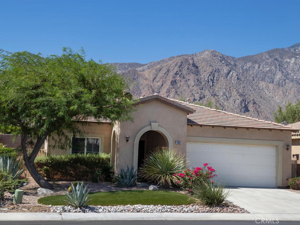 Desert Retreat living in the serene and highly desirable Mountain Gate community! A welcoming oasis greets you as you enter Palm Springs at 1103 Alta Cresta—a residence where the tranquility of the desert meets the convenience of downtown! Set against a backdrop of majestic mountains and swaying palms, this home offers the perfect combination of comfort and relaxation. Step foot into this beautifully maintained, move-in-ready home featuring 3 bedrooms and 2 full bathrooms. Boasting over 1,400 square feet of airy living space, the open-concept layout seamlessly blends the living, dining, and kitchen areas—ideal for entertaining or winding down after a day in the sun. The cozy fireplace in the living room, bar top island in the kitchen and putting green in the backyard makes this home the perfect place to be. The newer A/C unit, wood blinds and ceiling fans throughout help to keep things cool in the summer! Artificial grass and drip irrigated landscape make outside maintenance a breeze! When it comes to location this one checks all the boxes! Set across the street from the pool, basketball courts and various green spaces; this home is steps away from enjoying your community amenities. All within the neighborhood gates....keeping your enjoyment a bit more private. This Mountain Gate community is situated as such that it also offers easy access to world-class dining, shopping, golf, art galleries, and the vibrant downtown scene. Explore nearby hiking and biking trails, championship golf courses, and renowned spas. Across the way you will also find the Palm Springs Aerial Tramway—the world’s largest rotating tram car! Minutes from downtown, immerse yourself in the iconic mid-century modern architecture, design festivals, and the rich arts community that Palm Springs has to offer. Close to the Palm Springs International Airport and major freeways for effortless travel. Take advantage of this opportunity and delight in all the perks of the indoor/outdoor living and lifestyle that defines the charm of Palm Springs in every way. Book your private tour and viewing today!