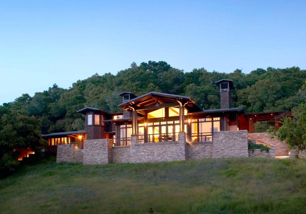 A Premier Setting at Santa Lucia Preserve. Set on one of the most desirable parcels along Rancho San Carlos Road just 3 miles from the Hacienda and 5 miles from the Gatehouse. 43 Rancho San Carlos Road offers a rare combination of privacy, natural beauty, and convenient access to both the vibrant Santa Lucia Preserve and the charm of Carmel-by-the-Sea. Designed by Hart Howerton Architects, the residence draws inspiration from Californias Arts and Crafts tradition and the timeless Prairie Farmhouse. The result is a home rich in craftsmanship and detail, yet light-filled and open to its surroundings. Inside, the homes heart features an open-concept living and dining area framed by expansive views of the coastal foothills. Two inviting sitting areas, each with a wood-burning fireplace, flank the dining space and open effortlessly to a spacious outdoor living terrace perfect for golden sunsets and star-filled nights. A gracious guest wing welcomes visitors at the eastern end of the home, while the private primary suite anchors the west, offering serene woodland views beneath a canopy of mature oaks. Quietly tucked into the landscape, a private study provides a retreat for reflection or creative pursuits, with a second study offering sweeping mountain vistas.