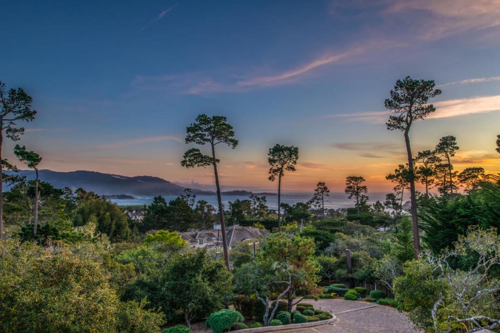 You are going to love this spacious, private, gated estate with fantastic views of Stillwater Cove located above The Lodge at Pebble Beach. There are large south facing windows bathing the interior with natural light and frame the scenic beauty of Carmel Bay and Point Lobos and the Pebble Beach Golf Course. The main level has high ceilings with exposed beams and is home to the beautiful primary retreat, an open space for your living room, dining area, breakfast nook that is bookended by two marble fireplaces and of course the kitchen with a sizable butler's pantry. Take the elevator down to the lower level where there is a family room, an amazing home theater with murals of Pebble Beach painted on the wall, a workout room and a wine cellar with a wine bar and 3 more ensuites and a large guest suite.
