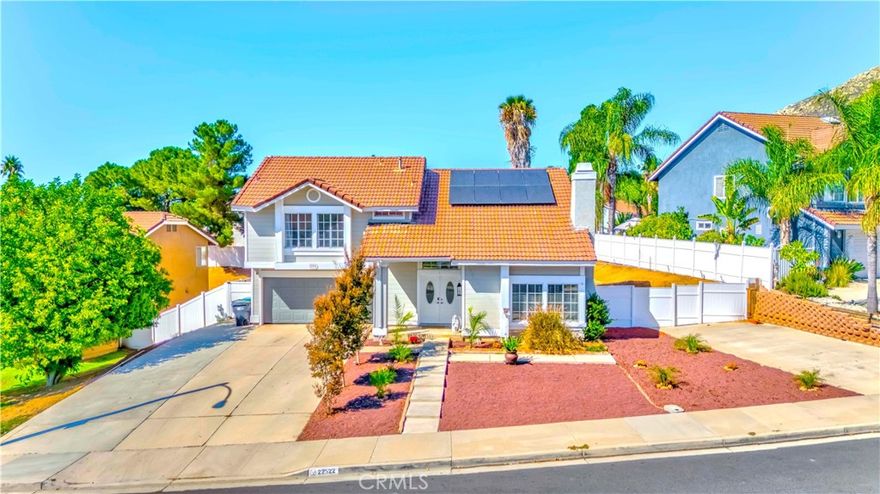 Welcome to this beautiful 1,932 sqft two-story home in Moreno Valley! featuring 4 bedrooms and 2.5 bathrooms. Surrounded by scenic hills and a stunning mountain backdrop, this residence welcomes you with brand new double doors, warm wide-plank flooring, warm-tone tile, and newer carpet throughout the bedrooms, all complemented by neutral tones. The second floor features an oversized primary bedroom with a his & hers bathroom sink, walk-in closet and beautiful plank flooring, plus three additional bedrooms and a full hallway bath for convenience. The main level offers a spacious living area with an inviting fireplace, a half bathroom, and a beautiful kitchen with an additional family room, perfect for seamless entertaining. Enjoy an expansive backyard ideal for gatherings, complete with a vinyl fence all around for added privacy and a full covered patio. It is the perfect canvas for your imagination! Plant fruit trees, for a vibrant garden or build a pool , or an ADU, etc. Iit is Conveniently Located just minutes from top-rated schools, shopping centers, hiking trails, and the General Old Golf Course, with quick access to the 60fwy and 215fwy freeways. This is a great house for growing families, at an affordable price! The house also includes SOLAR PANELS, great for saving all year round on that A/C and electronics! for a low monthly payment of $140. Call to make your appointment to view it today!