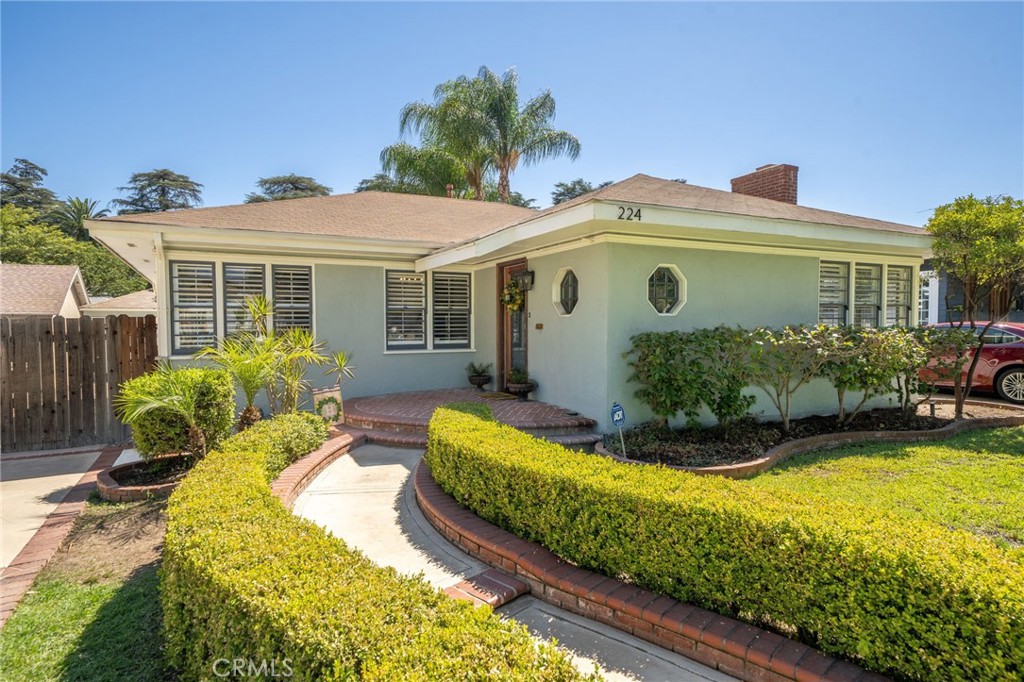 224 E Princeton Street, a timeless gem located in the highly sought-after historic College Park district of Ontario. Known as the Geza J. Kiss House, this residence was built in 1937 and exudes character, charm, and enduring craftsmanship while offering tasteful updates.
Set on one of the most desirable tree-lined streets in the city, this 3-bedroom, 1.5-bath home invites you in with its manicured landscaping and brick-accented walkway. Step inside to find original hardwood floors that flow throughout, preserving the home’s vintage soul. Distinctive details such as built-in cabinetry, original doors and hardware and shutters enhance the character of the living spaces.
The light-filled living room offers a warm and welcoming atmosphere, complete with a fireplace that anchors the space, perfect for cozy evenings with family. The dining room provides an intimate setting for meals, while a charming built-in bench adds both comfort and function.
The kitchen has been thoughtfully updated with rich wood cabinetry, granite countertops, and ample storage, blending modern convenience with traditional style. Natural light pours in through the surrounding windows, creating a bright and airy cooking space.
Each of the spacious three bedrooms offers comfort and practicality, with plenty of storage and classic finishes. The bathroom retains its timeless simplicity, complementing the home’s historic charm. Additional highlights include a dedicated laundry area and a partially converted garage that serves as a versatile office space, ideal for today’s work-from-home lifestyle.
Outside, the spacious yard provides room to relax, garden, or entertain. The tree-lined street and established neighborhood create a sense of community and pride of ownership that makes College Park so special.
Rarely does a home with this much history and character become available in such a coveted Ontario location. Whether you’re drawn to the preserved details of 1930s architecture or the inviting warmth of a family-friendly neighborhood, 224 E Princeton Street offers the best of both worlds.
As if this home couldn’t get any better—it also qualifies for the coveted Mills Act program, offering significant property tax savings. While homes in this neighborhood already enjoy relatively low taxes, the Mills Act can reduce them even further, potentially saving you $300–$600 per month in property taxes!
Own a piece of Ontario’s history in one of its most cherished neighborhoods.