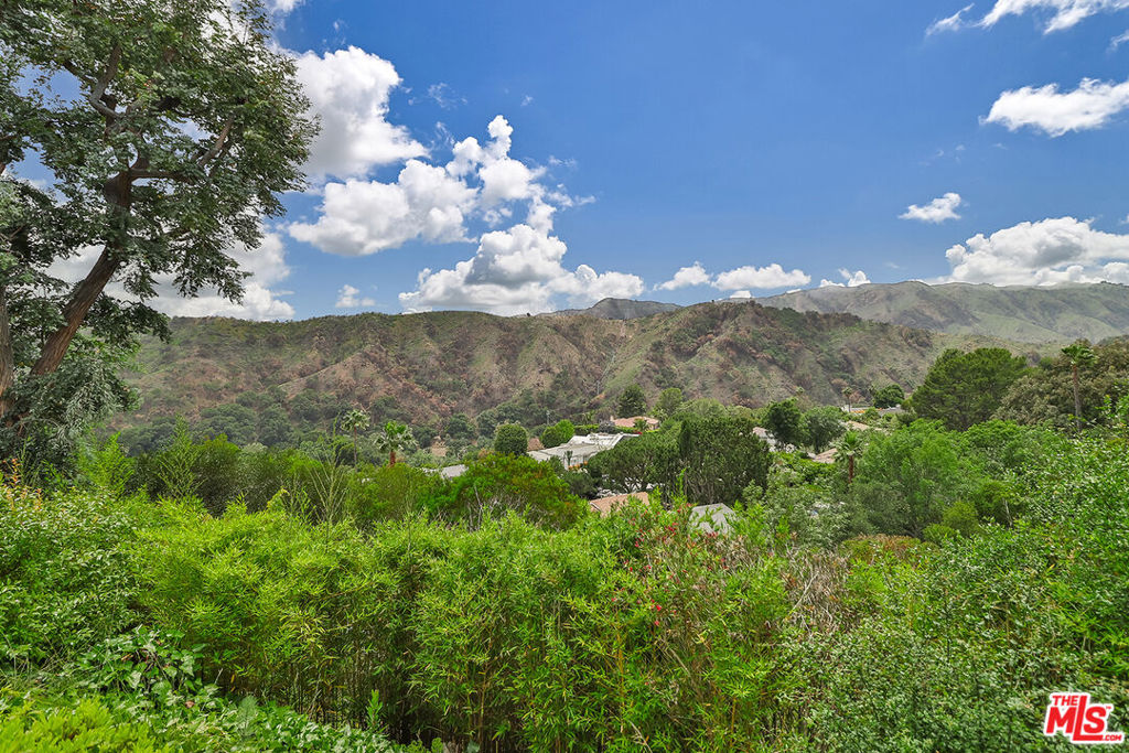 This single story Mandeville Canyon property offers incredible mountain views that are a must-see. While the home awaits modern updates, it offers great potential to make it your own. Four ample bedrooms and bathrooms span across this meticulously maintained residence designed for both entertaining and casual living. The home features two expansive living areas with an open design bathed in natural light, capturing breathtaking views. Let your imagination create a culinary oasis in this enormous kitchen which serves as the focal point of the home. The grounds offer ample space to expand and build an infinity pool overlooking the picturesque backdrop. New roof, two new air conditioning units and a newly installed "Generac" generator. Served by top rated schools, this community is superior for those seeking a balance of nature and an elite lifestyle.