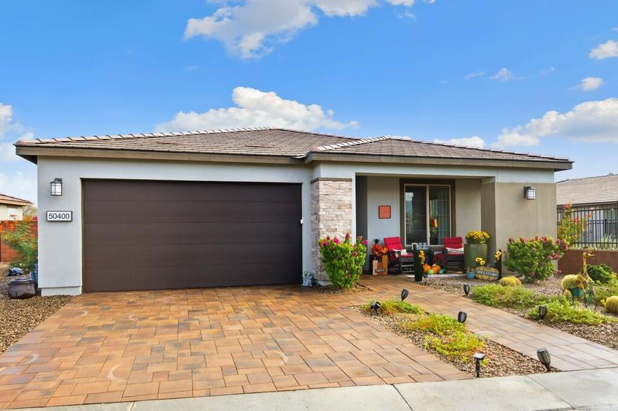 Gorgeous 3 bed, 2.5 bath home located in the highly desirable Trilogy at the Polo Club gated community! Offering great curb appeal with upgraded entryway lighting and pavers leading to a cozy porch and new glass front door, both of which provide stunning west facing mountain views. The home provides 1,847 Sq Ft of living space, sitting on a 6,395 Sq Ft double-sided premium lot with corner yard! The interior features a spacious and open floor plan with high ceilings, designer lighting and tile flooring throughout the home. The living room has a fireplace with a feature wall, and a full wall sliding glass door. The kitchen offers a large center island with bar seating, stainless steel appliances, and upgraded cabinets. There are 2 generously sized Primary Suites, each with a private ensuite. The additional 3rd room is currently being used as a media room but provides the new owners with versatile options and an added half bathroom across the hall for guests! Enjoy the entertainer's backyard with two putting holes that light up at night, a covered extended paver patio, and lush landscaping. This private yard has walking trails behind the home with mountain and garden views and is the perfect space for relaxing, sky-gazing or entertaining! This exceptional home also comes with leased solar, an extended garage with epoxy floors and its own A/C system and...... a Transferrable Polo Club Membership!!!!!! The community offers a full array of Resort-like community amenities including a restaurant, pools, spas, state-of- the-art fitness center, tennis courts, pickleball, endless activities, walking trails and so much more! This like new home is ready to be made yours, schedule your private tour today!