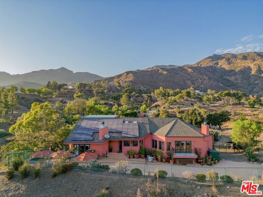 Malibu Retreat with forever mountain views and surrounded by open space! This private mountain oasis exudes the ultimate in tranquility. Almost 2 acres and adjacent to 160 acres of State Park land. There are easy and endless hiking and riding opportunities available. Gated and secluded, yet only 10 minutes to the beach, 15 minutes to Westlake/Thousand Oaks, and 15 minutes to Malibu's shopping and restaurants. 3 bedrooms, children's "playroom", 3.5 baths, large living room with fireplace and loft, gym with steam shower, infrared sauna, huge primary suite, oversized 3-car garage, with workshop/storage area, fruit trees, cactus garden, greenhouse, oak trees and seasonal stream. This home is essentially "off the grid" with solar, Tesla batteries, and well water. Separate and fully-equipped 2 bedroom, 1 bath private/detached guesthouse with 500 SF of deck available for an additional amount. Property is also for sale.