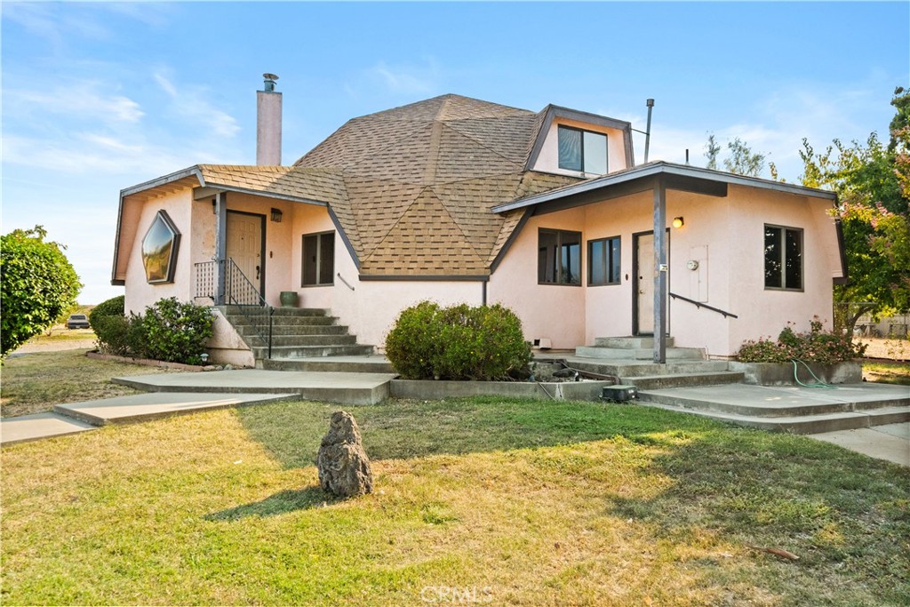 Unique, some may say out of this world, yet functional, this property is a true gem and has a lot to offer! Sitting on over 2 acres just outside of Corning, California, this home was custom built with 2 bedrooms plus a loft and 3 bathrooms sparling over 2,400 sqft. Downstairs features an open floor plan with tall ceilings in the living room, a fireplace, and large windows for natural light. In the kitchen, there is plenty of counter space for prepping the perfect meal, lots of storage, an island with an electric cooktop, and the perfect spot for sharing stories in a retro style built-in dining table. The primary bedroom has an darling vanity area, mirrored closet doors, and en suite bathroom with a tile walk-in shower. The second bedroom is down the hall with the guest bathroom nearby. Upstairs offers a loft space that has lots of possibilities! With a bathroom and closet, this could double as a guest room, a play room, home gym, office, or a game room. There is also an indoor laundry room off the kitchen with access to the exterior. Outside there is a detached oversized two car garage and a partially fenced yard. There is opportunity and space to garden, raise 4H animals, or maybe even add a second unit. This home is one of a kind and is waiting for you to make it your own!