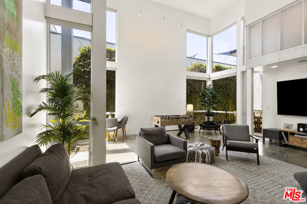 This architectural art loft, located in the heart of Venice just one block from the beach, captures the essence of the neighborhood, offering the freedom to live creatively and on your own terms. Its rare and adaptable lot provides exceptional potential, with versatile zoning that opens the door to endless possibilities, whether as a traditional residence, a creative office, a live/work space, or even a service-based business with storefront potential. This one-of-a-kind property is ready to bring your vision to life. Flooded with natural light, the front room boasts soaring ceilings, polished concrete floors and a great outdoor space. The home spans multiple levels, with private balconies and windows that continue the theme of openness and light throughout all while being gated, private and secure with two car garage and additional parking in the driveway. It is currently configured as 5 bedrooms, with the option to restore it to a single large primary suite as originally designed, Whether you're seeking a home, a workspace, or a seamless blend of both; discover the possibilities and make it your own.
