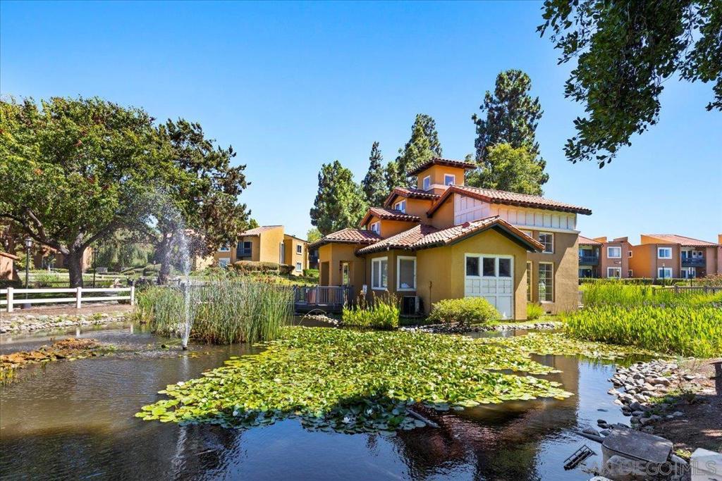Tucked within the tranquil, park-like setting of the Waterbridge community in Rancho Bernardo, this beautifully appointed second-story end-unit offers a rare blend of privacy, natural light and thoughtful design. With only one shared wall, the home welcomes you with rich wood flooring that leads to an expansive living room adorned with soaring beamed ceilings and a serene private balcony. The open-concept layout flows seamlessly into a sun-drenched dining area and an upgraded kitchen featuring timeless granite countertops, stainless steel appliances, and generous cabinetry. There are two well-proportioned bedrooms, including a spacious primary suite with an oversized closet and a modern ensuite bathroom complete with designer cabinetry, granite surfaces, and a tastefully remodeled shower. A clever 1.5-bath configuration provides a separate vanity for added convenience and privacy. Additional highlights include central A/C, in-unit laundry with a stacked washer/dryer in the private balcony closet, dual-pane windows, and a dedicated parking space. Residents of Waterbridge enjoy beautifully landscaped grounds with meandering walking paths, tranquil ponds with fountains, and resort-style amenities such as a sparkling pool, separate children’s pool, spa, fitness center, clubhouse, BBQ and picnic areas and a playground. Ideally located just across from the Westwood Club and minutes to Westwood Elementary, local dining, shops, and major freeways, this home offers both peaceful retreat and everyday convenience in one of San Diego’s most desirable neighborhoods.