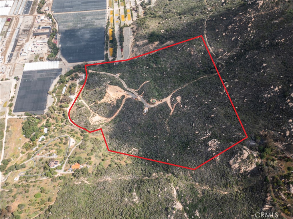 Incredible opportunity to own 36.61 acres of gently rolling land in the serene hills of Fallbrook. Located in San Diego County and zoned A70, this expansive parcel offers a variety of possibilities including agricultural development, a custom home site, equestrian use, or potential future investment. The property boasts sweeping panoramic views of surrounding mountains and valleys, delivering the peace and privacy of rural living while still being conveniently located just minutes from I-15 and the communities of Rainbow, Fallbrook, and Temecula.
Accessed via a quiet dirt road, the land features natural vegetation, mature trees, and multiple potential building sites. The terrain is a blend of flat and sloped areas, ideal for a wide range of uses. Whether you’re looking to establish a private estate, vineyard, grove, or recreational retreat, this property provides the flexibility and space to bring your vision to life.
Located near the heart of Southern California’s agricultural belt, this parcel benefits from the region’s favorable climate and soil conditions. The surrounding area includes nurseries, groves, and custom homes, creating a peaceful yet vibrant rural community atmosphere.
Enjoy stargazing, hiking, or off-roading on your own land with unmatched privacy and tranquility. Opportunities like this rarely come available in such a prime location. Buyer to verify zoning, land use potential, and availability of utilities to satisfy intended use. Drive-by OK; ideal vehicle is all-terrain or 4x4 due to rural road conditions.
This is your chance to own a slice of California countryside with room to grow, build, and explore.