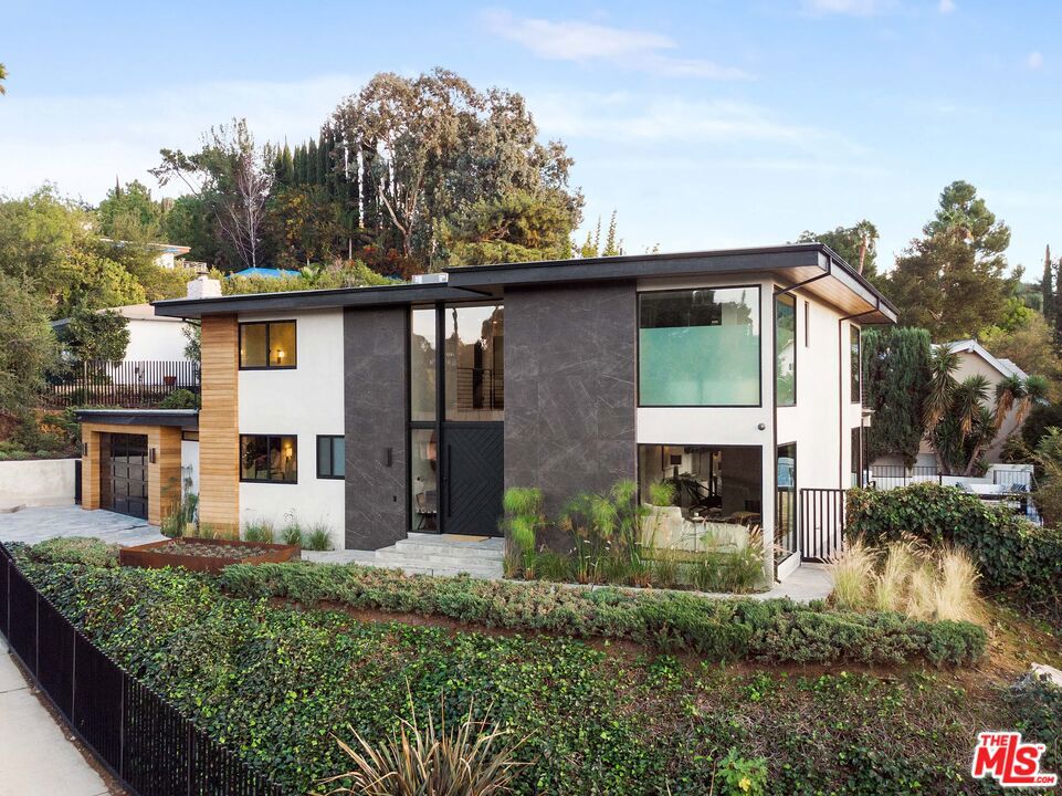 Recently renovated, we are proud to present this luxury, contemporary, home perched upon one of the preeminent streets in the Dona's and delivering panoramic views over the surrounding Mullholland Corridor. This secure, privately gated compound is set over almost 3900sf and features a sprawling Master Bedroom Suite, with two large walk in closets, and a light soaked master bathroom set with natural stone and private balcony. Beyond the premier suite are FIVE additional bedrooms, each with their own en-suite bathrooms and fully fitted walnut closets. Downstairs the glass filled atrium with expansive 30' ceilings, leads to two large living rooms, a dining room and sleek contemporary kitchen set with Wolf appliances, retractable windows and sliding Fleetwood doors opening up the living space to the expansive outdoor pool and entertaining area, complete with fire pit, cabana, and built in barbecue area.