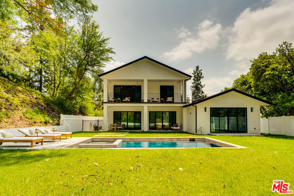 Tucked at the end of a quiet cul-de-sac in the prestigious Lanai School District, this newly built modern farmhouse offers the perfect blend of luxury, comfort, and privacy. With a total of 4,515 square feet, the property includes a 4,100 sq ft main residence and a 415 sq ft fully equipped ADU ideal for guests, extended family, or rental income. Designed with clean lines, natural textures, and thoughtful open-concept living, the home features 6 spacious bedrooms and 7 designer bathrooms. The gourmet kitchen is a showstopper with custom cabinetry, and an oversized island that flows seamlessly into the expansive living and dining areas. Fleetwood doors open to a beautifully landscaped backyard oasis perfect for indoor/outdoor living with space for entertaining, lounging, and enjoying California's year-round sunshine. Just minutes from Ventura Blvd yet tucked away in a peaceful enclave, this exceptional home offers both elegance and convenience in one of Encino's most sought-after locations.