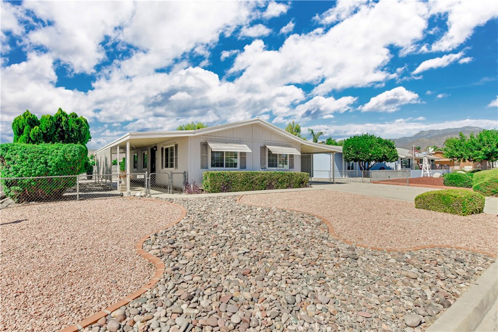 Welcome to Monte Vista Estates East a vibrant 55+ community in East Hemet where low HOA dues meet well-maintained surroundings. This natural light-filled 2 bedroom, 2 bath home offers 1,176 sqft of thoughtfully laid out living space. The open living and dining areas flow naturally into a bright and functional kitchen. A dedicated laundry room adds to the everyday convenience. The home sits on a 6,970 sqft lot with easy care landscaping, a private fenced yard, and a covered carport a simple, low-maintenance setup ideal for relaxing or entertaining. As part of Monte Vista Estates East, you’ll enjoy a friendly and established 55+ community with very low HOA dues, clean infrastructure, and peaceful streets with curbs, gutters, and street lighting. The location offers quick access to main roads, nearby shopping, and medical facilities, all while maintaining a quiet neighborhood feel. Perfect for those looking to downsize or simplify without sacrificing comfort, schedule your private showing today!