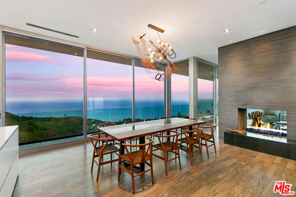 Stunning modern masterpiece designed by award-winning architect Steve Kent, AIA. A true architectural gem, crafted with impeccable quality and extraordinary attention to detail. Walls of custom glass seamlessly open to expansive wraparound decks, revealing jaw-dropping, 180-degree panoramic whitewater views from Santa Monica and Catalina Island to the Malibu Pier to Point Dume and beyond. The main house features 4 bedrooms, 4 bathrooms, a private office, and a state-of-the-art media room. A separate 1-bedroom, 1-bathroom guest house with its own private entrance offers ultimate flexibility perfect for guests, a home office, or a recording studio.The sleek Boffi kitchen is outfitted with top-of-the-line Miele appliances including a cooktop, ovens, and built-in espresso machine, complemented by twin Sub-Zero refrigerator/freezers and a built-in Sub-Zero wine cooler. Modern conveniences include fiber-optic internet, a central vacuum system, and a fully integrated sound system throughout the home and outdoor spaces. The setting is exceptionally private, surrounded by natural beauty, yet just three minutes from PCH. Included are two additional parcels: one adjacent lot for additional privacy, and a third lot that grants coveted membership to the exclusive La Costa Beach and Tennis Club. The home also includes membership to the private, guard-gated section of Rambla Pacifico. An extraordinary opportunity to own a one-of-a-kind coastal retreat blending modern luxury, privacy, and panoramic views. Includes the following APN #'s: 4453-011-005 | 44453-010-005 | 4451-022-032. Can be sold furnished and turnkey.