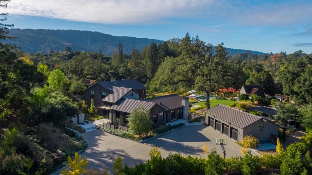 On Woodside's most prestigious street, a stone's throw to town and school, this estate, newly built in 2015, has been completely transformed since then into an exquisite retreat, elegant yet completely livable, with a profound respect for materials and craftsmanship. This modern farmhouse was reimagined by a team of leading design professionals; Feldman Architecture, Kendall Wilkinson Design, and Arterra Landscape Architects. Firmly rooted in a California aesthetic, every room offers clean-lined sophistication with wall, floor, and surface selections organic in nature, blending in harmony with the surroundings. Three levels plus a separate guest house provide every amenity desired for today's lifestyle of working from home, distance learning, entertainment, fitness, and wellness. Perfectly situated in complete privacy on over 3 acres in an extraordinary setting with finishes that are second-to-none, this is truly an exceptional home midway between San Francisco and Silicon Valley.