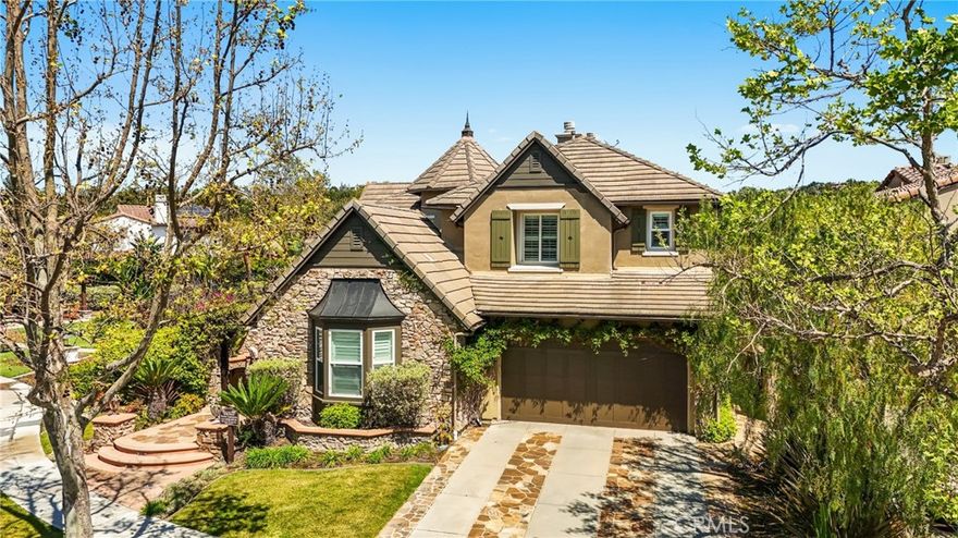 Huge Price adjustment. Welcome to this beautifully crafted French country-inspired estate, located at the end of a peaceful cul-de-sac and next to a tranquil greenbelt, offers a blend of luxury, comfort, and convenience. The impressive courtyard sets the tone, inviting you to step inside and experience the warmth of a romantic outdoor fireplace hearth.

The main living areas include expansive formal living and dining rooms, an open-concept kitchen with a central island, stainless steel appliances, and a cozy breakfast nook. The adjoining family room offers ample space for relaxation, and the lower level includes a generously sized guest en-suite bedroom.

Upstairs, a grand Cinderella staircase leads to a magnificent master suite, complete with a private balcony offering scenic views. The luxurious master bath features intricate leaded glass windows and custom finishes. Two spacious ensuite bedrooms, along with a large loft area equipped with built-ins, a decorative balcony, and a convenient hobby niche, complete the upper level.

The private Casita could easily be converted into yet another bedroom. Throughout the home, custom millwork, arched doorways, trim, and built-in cabinetry add both elegance and practicality. The finishes include natural stone floors, elegant granite countertops, custom wood cabinetry, tailored window treatments, and neutral paint tones that enhance the home’s timeless appeal.

The rear grounds are perfect for entertaining, with a built-in BBQ island, seating area, and a lovely ambiance. A three-car tandem garage with epoxy flooring completes this dream estate, making it the perfect home for any discerning buyer. Conveniently located near schools, a clubhouse, sports courts, a water park, and the central paseo, this estate offers both privacy and accessibility. 24 Hour guarded Covenant Hills Community offers the Best in Orange County Living.