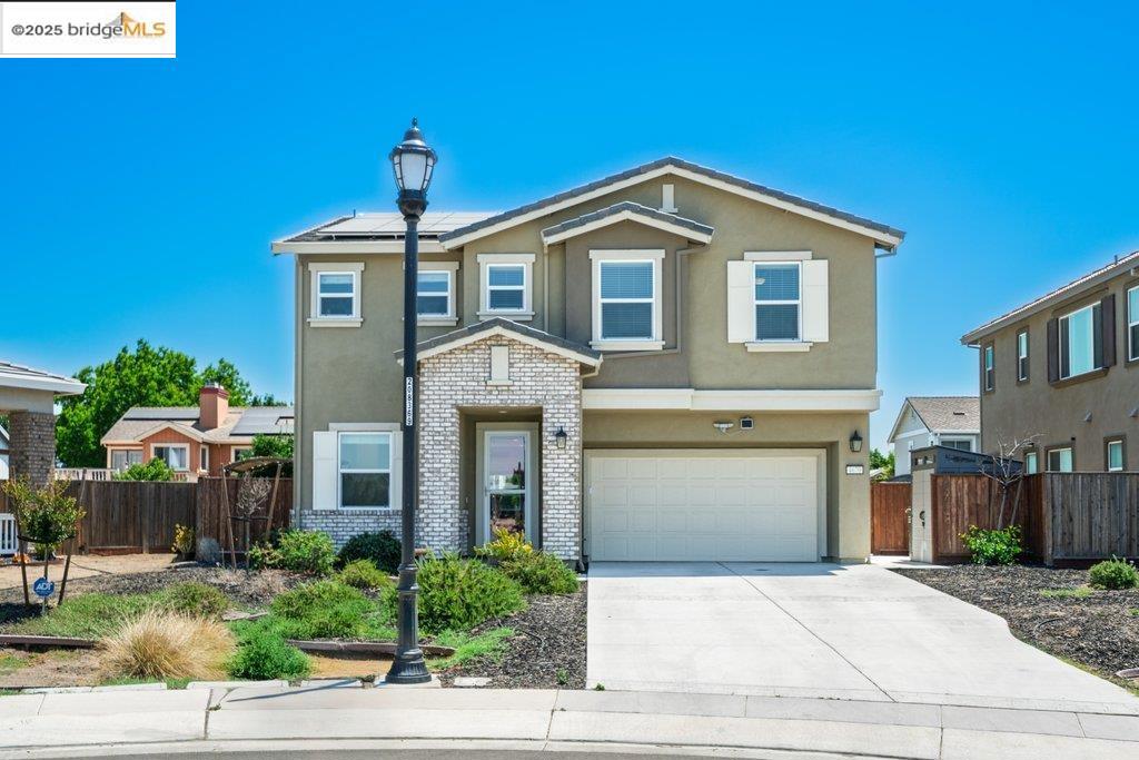 Welcome to this nearly new 5-bedroom, 3-bath home built in 2022. The open floorplan includes a modern kitchen with granite counters, stainless steel appliances, a breakfast bar, walk-in pantry, and dining area that flows into the main living space. A bedroom and full bath on the first floor offer flexibility for guests or multi-generational living. Upstairs features a loft, laundry room, and spacious primary suite with dual sinks, soaking tub, and separate shower. Energy-efficient upgrades include paid solar, a tankless water heater, and EV charging station. The backyard is low-maintenance with artificial grass, a covered patio, gazebo, raised garden bed, and elevated sitting area. Conveniently located near shopping, schools, parks, and freeway access.