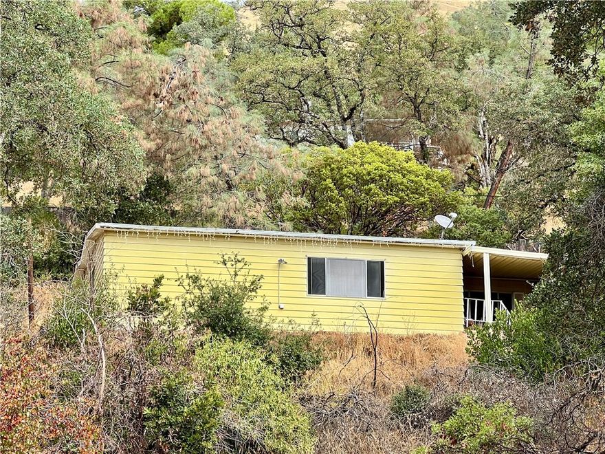 This 1977 Silvercrest Howard Manor Triplewide manufactured home offers 3 bedrooms and 2 bathrooms, perched on a hillside with beautiful views of Clear Lake and the surrounding hills and trees. The home features a spacious floor plan with great potential. While it is in need of updating and repairs, it presents an excellent opportunity to create a truly magnificent residence where you can relax and enjoy the scenery. Additional highlights include: • A detached shop/storage building  •  A paved driveway with extra parking areas • A solid concrete retaining wall behind the home.  With its size, layout, and setting, this home is a rare find that’s ready for someone with vision to make it shine.  The home is on post and pier and not on a 433 foundation retrofit.