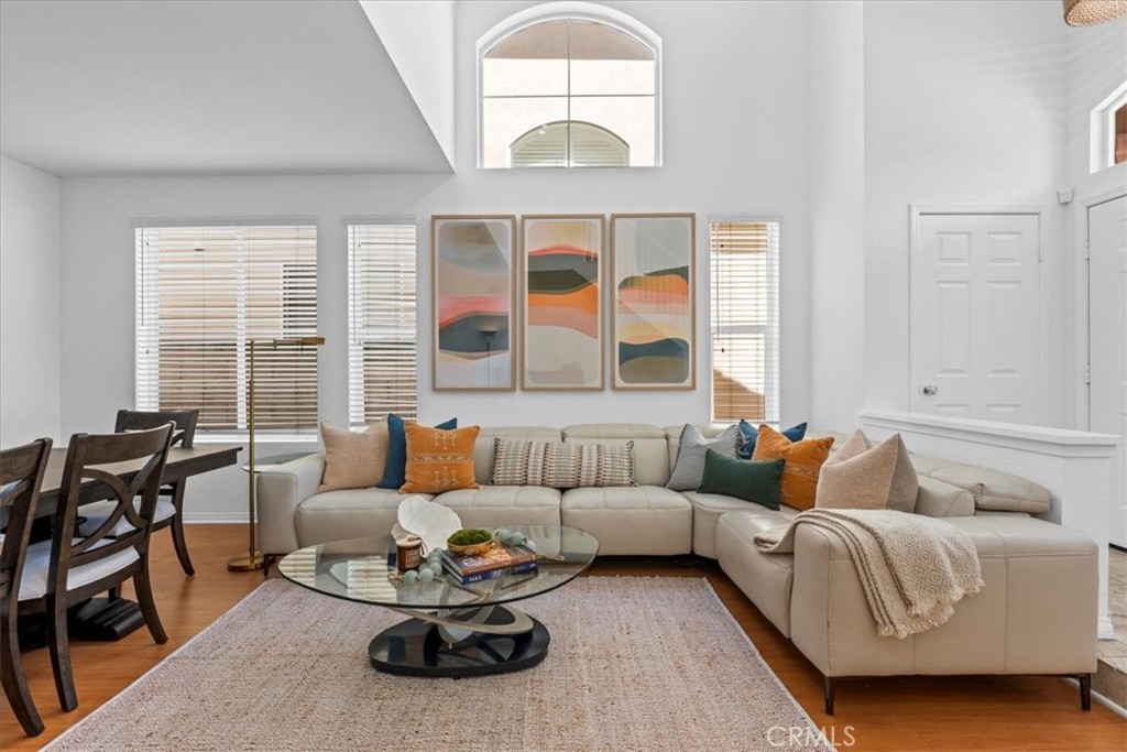 Ideally located just minutes from downtown Huntington Beach, the iconic pier, top-rated restaurants, shopping, and miles of scenic coastline, this beautifully designed 4-bedroom, 2.5-bathroom home offers the perfect blend of coastal charm and everyday convenience. The spacious main level features soaring ceilings in the living room, flowing seamlessly into the inviting family room, dining area, and well-appointed kitchen—ideal for both entertaining and daily living. Enjoy direct access from the attached 2-car garage to the kitchen for added ease. Upstairs, a versatile loft provides the perfect space for a home office or study area. The second floor also includes four generous bedrooms and a convenient laundry room. The bright, airy primary suite offers mirrored wardrobes and a spa-inspired bathroom with a Roman jetted tub, separate shower, and dual vanities. Additional features include travertine finishes in the shared bathroom, recessed lighting, and large windows throughout that fill the home with natural light. This is coastal living at its finest—don’t miss your chance to call this exceptional home yours!