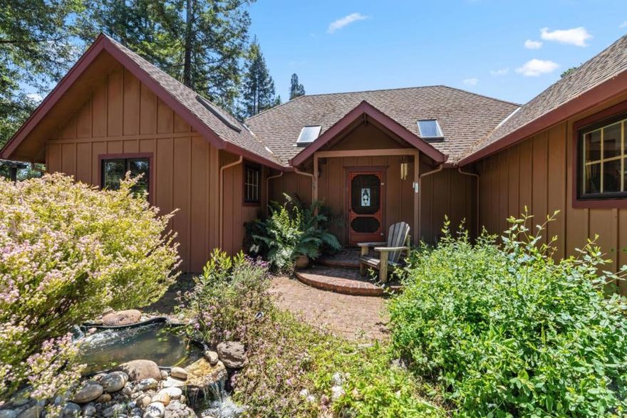 Get away from it all, relax and take in breathtaking views of the Santa Cruz Mountains and Monterey Bay from this epic 28-acre ridgetop estate. This expertly designed 3-bedroom, 2-bathroom home features picture windows in every room, bringing the outdoors in and flooding the space with natural light. Upon entry, curved archways, vaulted ceilings, and beautiful hardwood floors create a warm, inviting atmosphere. Enjoy the peace of a decorative pond, abundant privacy, and a connection to nature that is second to none. Incl 2 parcels (8ac/20ac). The property is fully equipped for modern comfort with a state-of-the-art owned solar system, a reliable private well, and excellent internet and cell service. A large detached barn features a 400-square-foot workshop, perfect for woodworkers or hobbyists. Grow an organic vegetable garden that can thrive in the sunny mountain climate, with a potting shed, attached cold frame, and hotbox for year-round growing. The primary bedroom boasts an adjoining walk-in closet and a dramatic bathroom with an oversized soaking tub. Located at the end of a private country road, this property is a rare opportunity to embrace a homesteading lifestyle in one of California's most beautiful regions with all the peace, privacy, and adventure you could desire!
