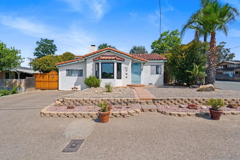 Welcome to your charming home with multi-generational flexibility and timeless character! This beautifully maintained 3-bedroom, 2-bathroom home offers a flexible layout that’s perfect for split living situations. Whether you're looking for multi-generational options, guest space, or extra privacy, the home provides a variety of possibilities to suit your needs. With 1,121 square feet of living space, this home is filled with warmth, history, and just the right touch of modern updates. Step inside and you’ll be greeted by original 1930's details like refinished oak floors, tray ceiling, authentic base moldings, built-in cabinets, built-in drawers, and a charming linen cabinet. The living room centers around a custom fireplace with a live-edge oak mantel and original terracotta tile hearth, paired with a large bay window that lets the natural light pour in. The separate laundry room adds convenience, while the fully fenced backyard offers a double gate for RV access or extra parking with a detached garage. Sitting on a flat, usable corner lot just under a quarter acre, there’s plenty of space to garden, play, or relax. Enjoy mature fruit trees including tangerine, lemon, grapevine, passionfruit, and fragrant plantings like white lilac, mountain sage, and milkweed. Other updates include attic insulation and a roof with a 50-year guarantee.This home has been lovingly cared for and is now ready to welcome its next chapter. Come experience the charm, comfort, and flexibility this unique property has to offer.