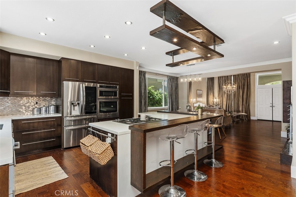 Welcome to this beautiful dream home. A fully-remodeled jewel in the heart of RSM offers a chic sanctuary with modern designer upgrades and amenities is available partially-furnished with outdoor furnishings. The moment you enter this home, you're greeted with warmth and style. The open floor plan offers all the desired items on the checklist of most clients. The first floor offers lots of natural light from many windows, a large formal living room & dining room with vaulted ceilings, open to a chef's kitchen with a unique center island, custom island and bar seating, stainless steel appliances, including a double-oven, fridge, dishwasher, cooktop, and plenty of storage and cabinet options. A large and cozy family room is open to the kitchen and enjoys the warmth and relaxing atmosphere created by warm tones & a beautiful fireplace, as well as a retreat, perfect as a home office, or study station. A modern 1/2 bath completes the first floor amenities. An updated and low-maintenance backyard is ready to help you relax and unwind at the end of a busy day or week and celebrate time with your loved ones and guests. An outdoor kitchen and BBQ station will provide all you need to complete your indoor/outdoor living celebrations, or just a quick week-night meal. Upstairs plan offers ample space or today's households with 4 bedrooms, two full bathrooms and a bonus room, as well as a laundry room, including washer & dryer. Primary suite offers a remodeled en-suite bathroom, and a walk-in closet and dressing area. A low maintenance and drought-friendly front yard and front porch complete the lovely appeal off this home. Garage offers cabinets, and EV Charger options. Highly-sought-after Arroyo Vista Elementary & Middle Schools are about 1/4 mile away, just next to Arroyo Vista Sports Complex and Jr. Olympic Size Pool & Spa. Enjoy all RSM and SAMLARC amenities which are just about a half a block away from the driveway!